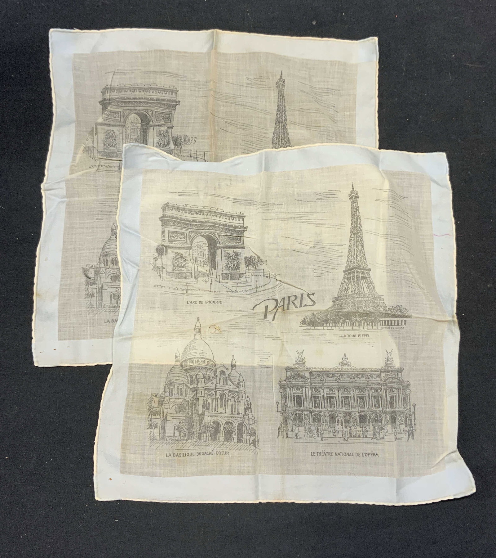 Lot 2 Paris Souvenir Travel Cotton Handkerchief: Lot 2 pair of vintage travel souvenir Paris Handkerchief with architectural motifs. Material feels like cotton. Measures approx. 11.5 x 11 inches. Wear to both pieces including blemishes observed. Han