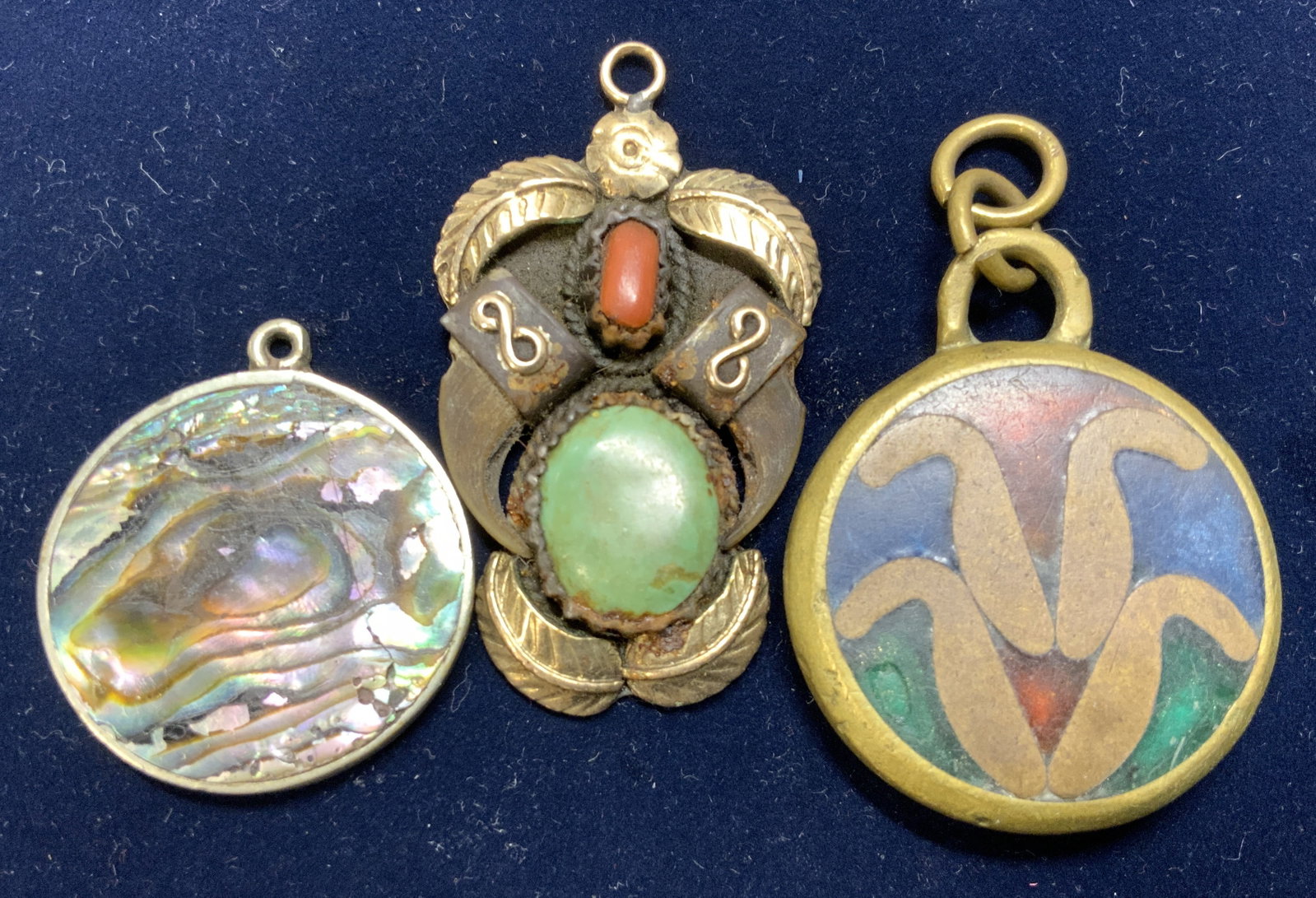 Lot 3 Artisanal Pendants, Sterling Silver Abalone: Chunky enamel pendant set in brass, 1.75 x 1.5 in. Approx 1/4 in. Deep and has weight. Hand crafted Native American style pendant with leaves and stones, 2 x 1.25 in. Both of these have some wear/ dis