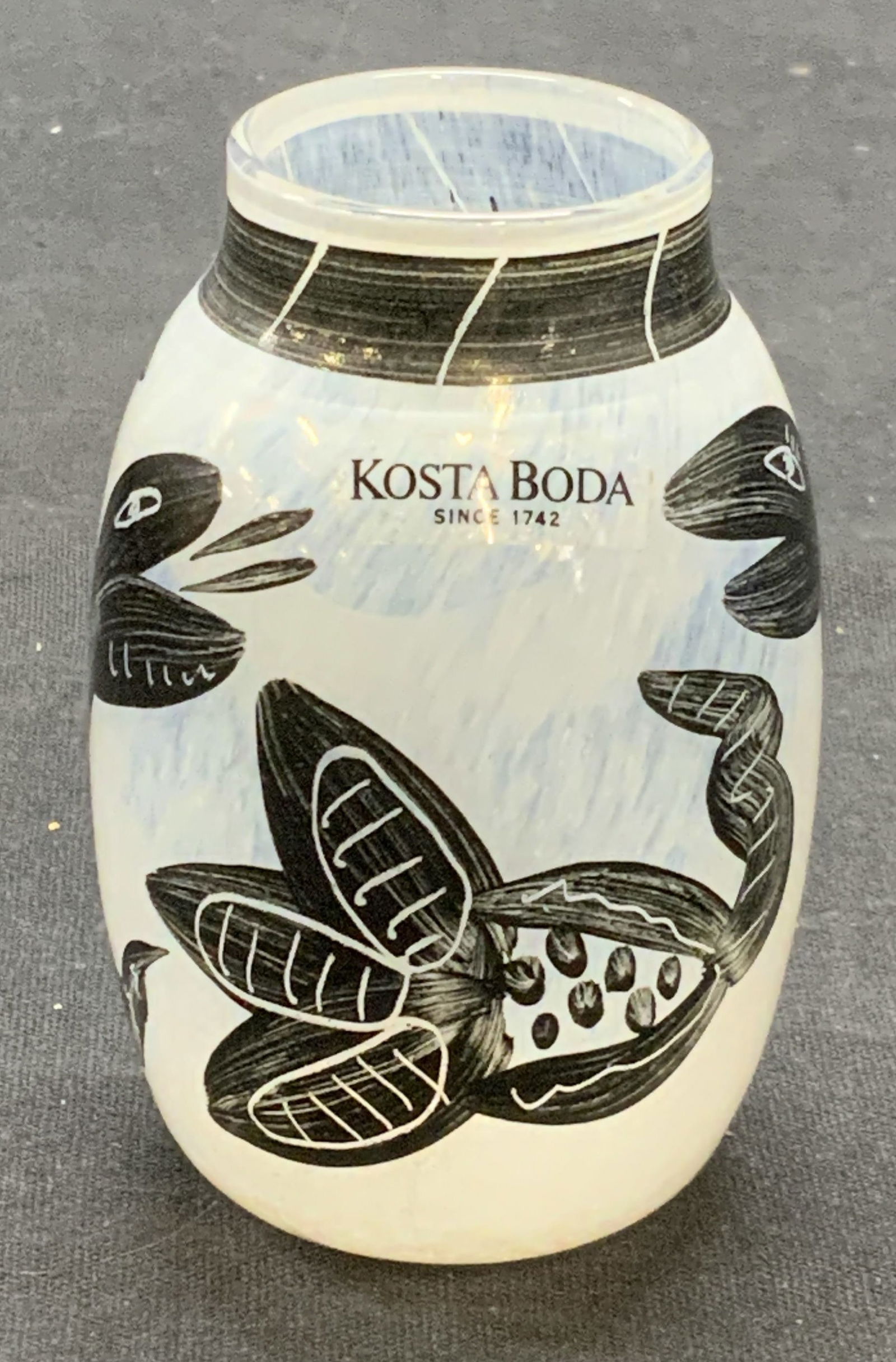 KOSTA BODA Hand Painted Art Glass Vase: KOSTA BODA hand painted white and black art glass vase with animal motif. Signed in sticker. Measures approx. 1.75 x 3 inches. Some surface wear including scratching observed. KOSTA BODA, KOSTA BODA v