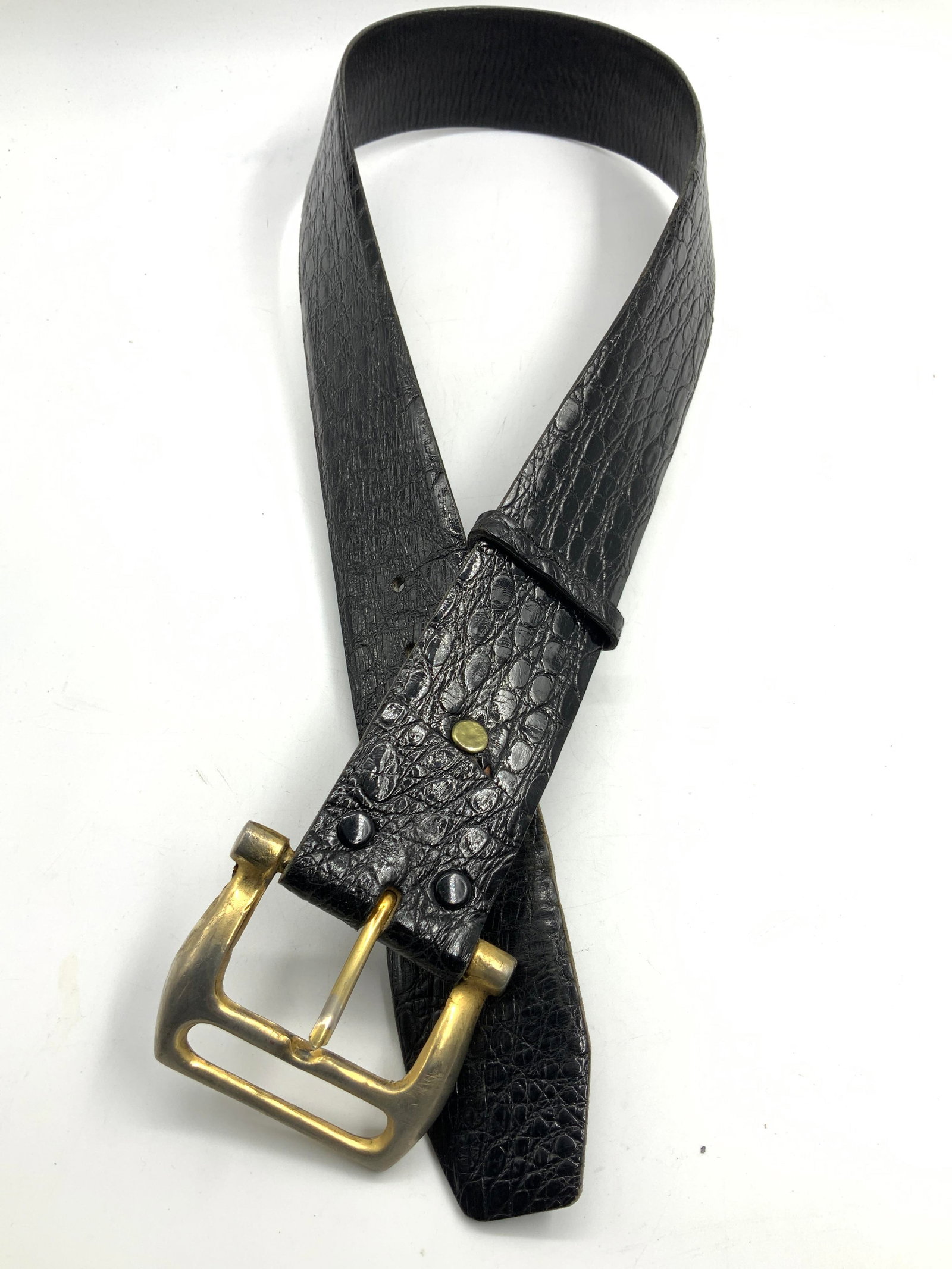 Alligator Skin Leather Belt: Black toned alligator skin leather belt with brass buckle. Marked genuine alligator skin. 34. approx 33 inches long and 2 inches aside. Buckle being, 3 inches wide. Moderate wearing to holes on leathe