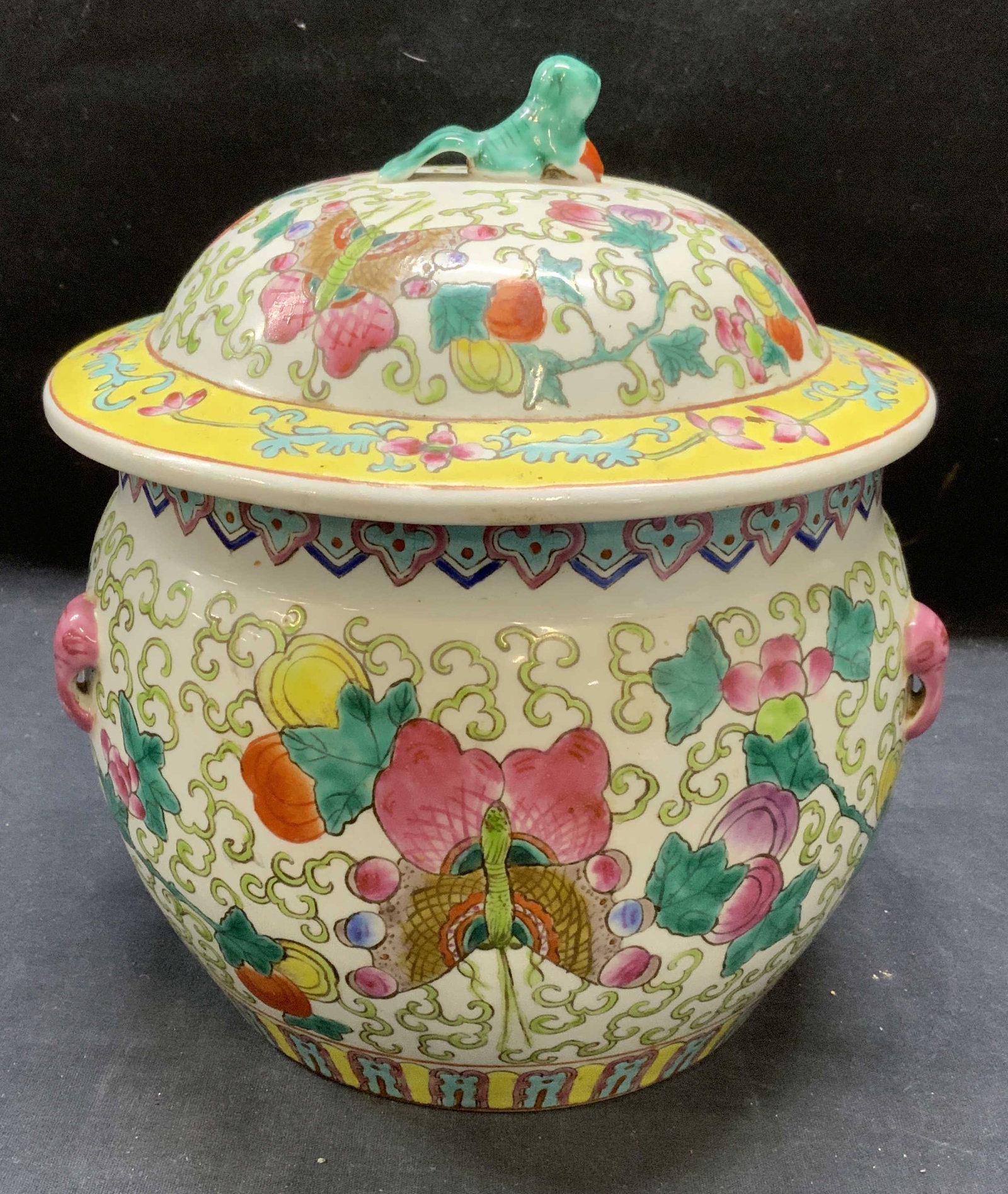 Vintage Stamped Chinese Lidded Porcelain Jar: Vintage stamped Chinese lidded porcelain jar with butterfly and floral motif. Hand painted in hues of pastel yellow, pink, blue, and green. Measures approx. 7.5 x 6.25 inches excluding lid. Red seal s