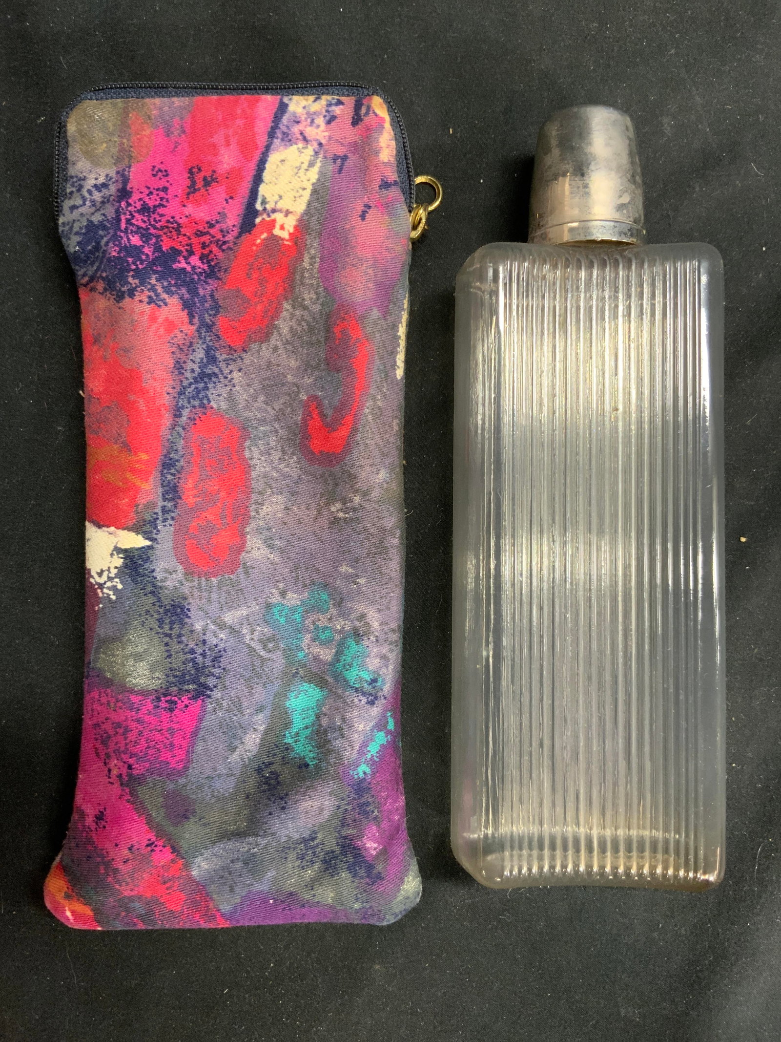 EXCLUSIVE GERMANY Flask & Case: Cap is inscribed EXCLUSIVE GERMANY With shield trademark. Lot includes flask and flask case. Flask case has zippered top & Multi toned detail print. Flask is plastic. Cap is silver toned metal. Piece 