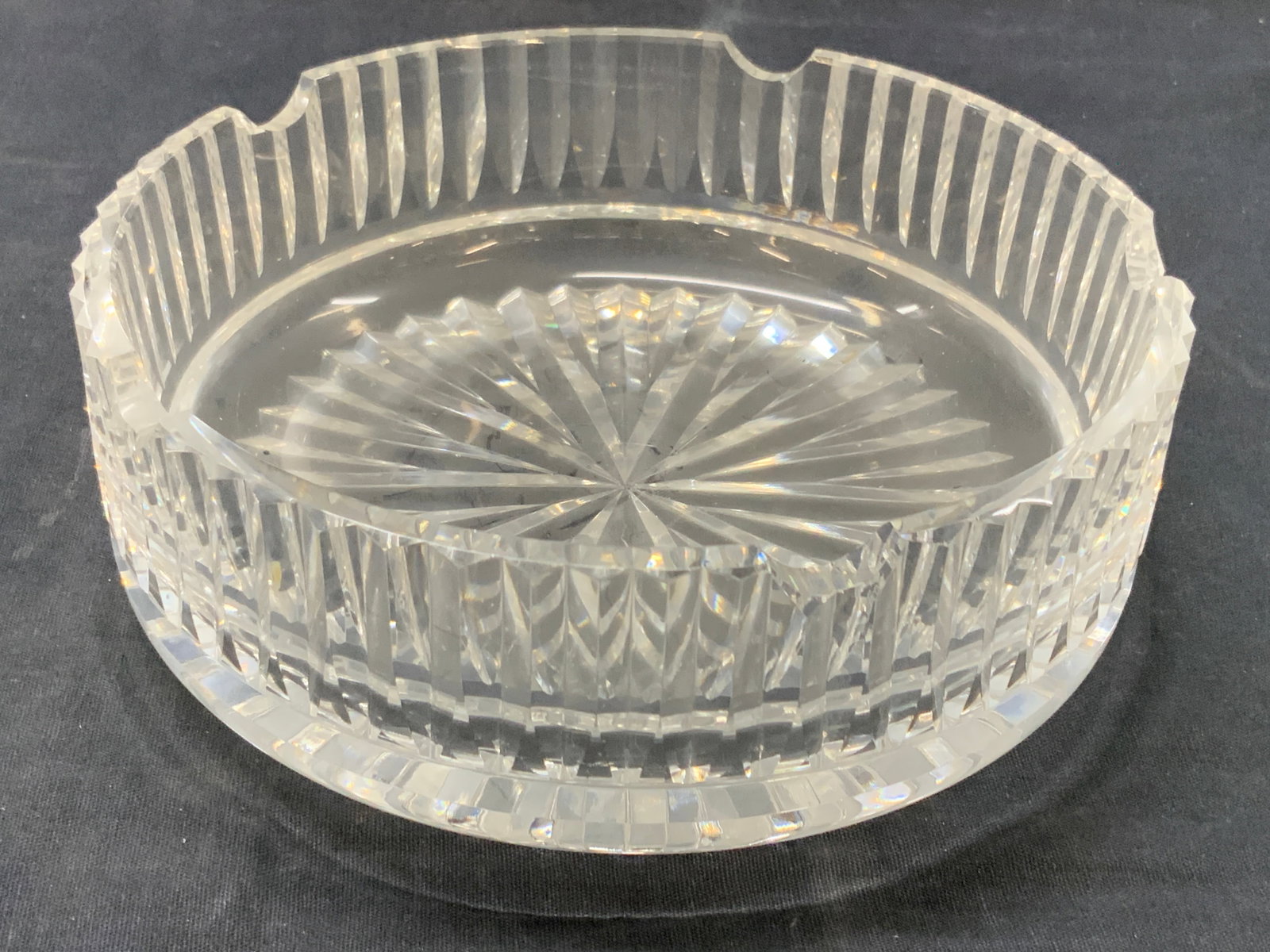 Thick Walled Cut Crystal Bowl: Thick walled cut crystal ash Ray bowl with vertical grooves on edges and Star bursts underside. Approx 2.5 inches tall and 7 inch diameter. Moderate wearing to edges of crystal Crystal ash tray. Ash t