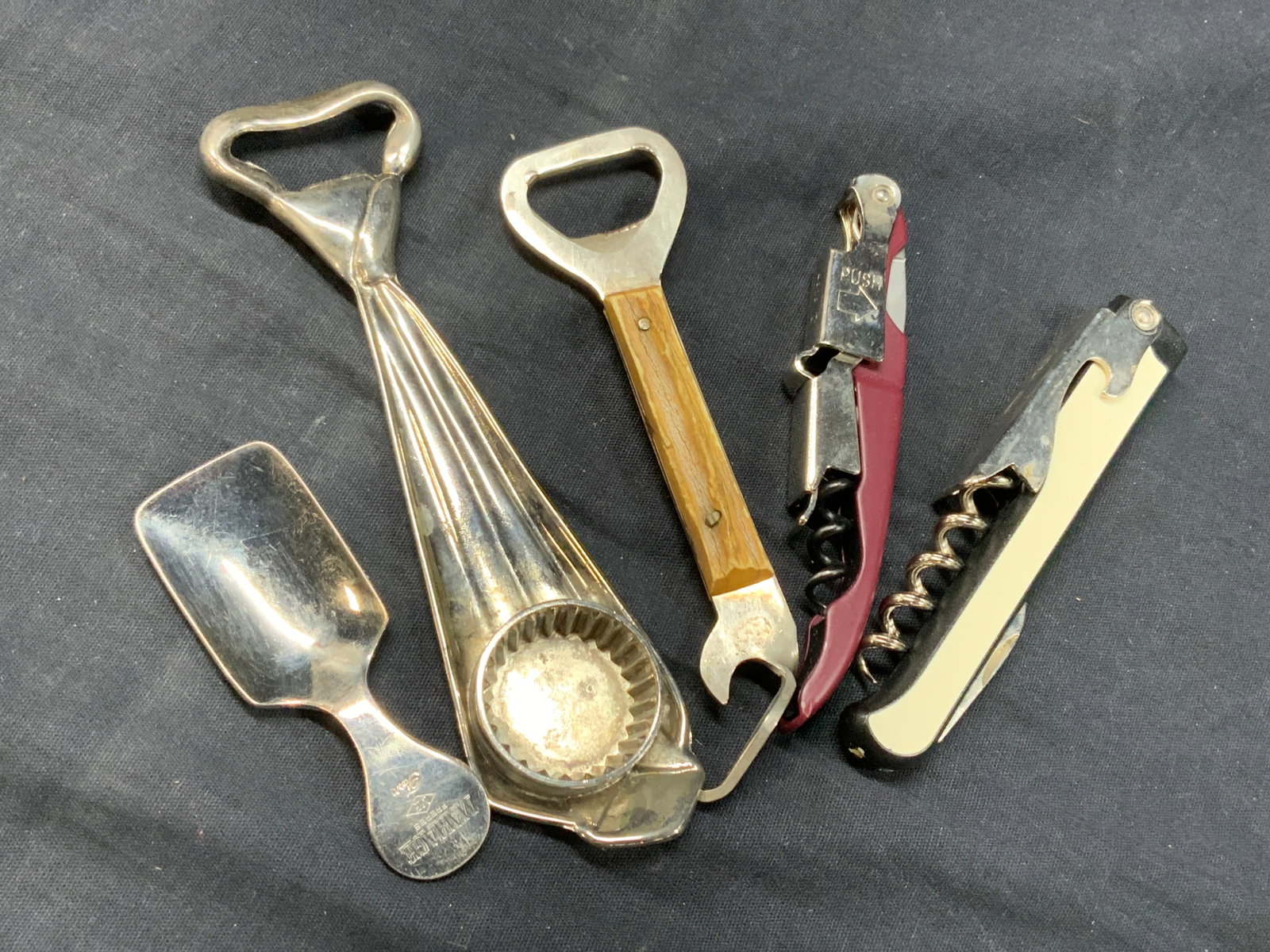 Lot 5 Vtg Bottle Openers, Hoffritz, & More, Italy: Lot of 5 vintage bottle openers. 2 wine bottle openers with screws. 1 marked Hoffritz and the other Rabbit. Approx 4 inches long. 1 metal opener with wooden handle and 1 silver plate opener at 6.5 inc