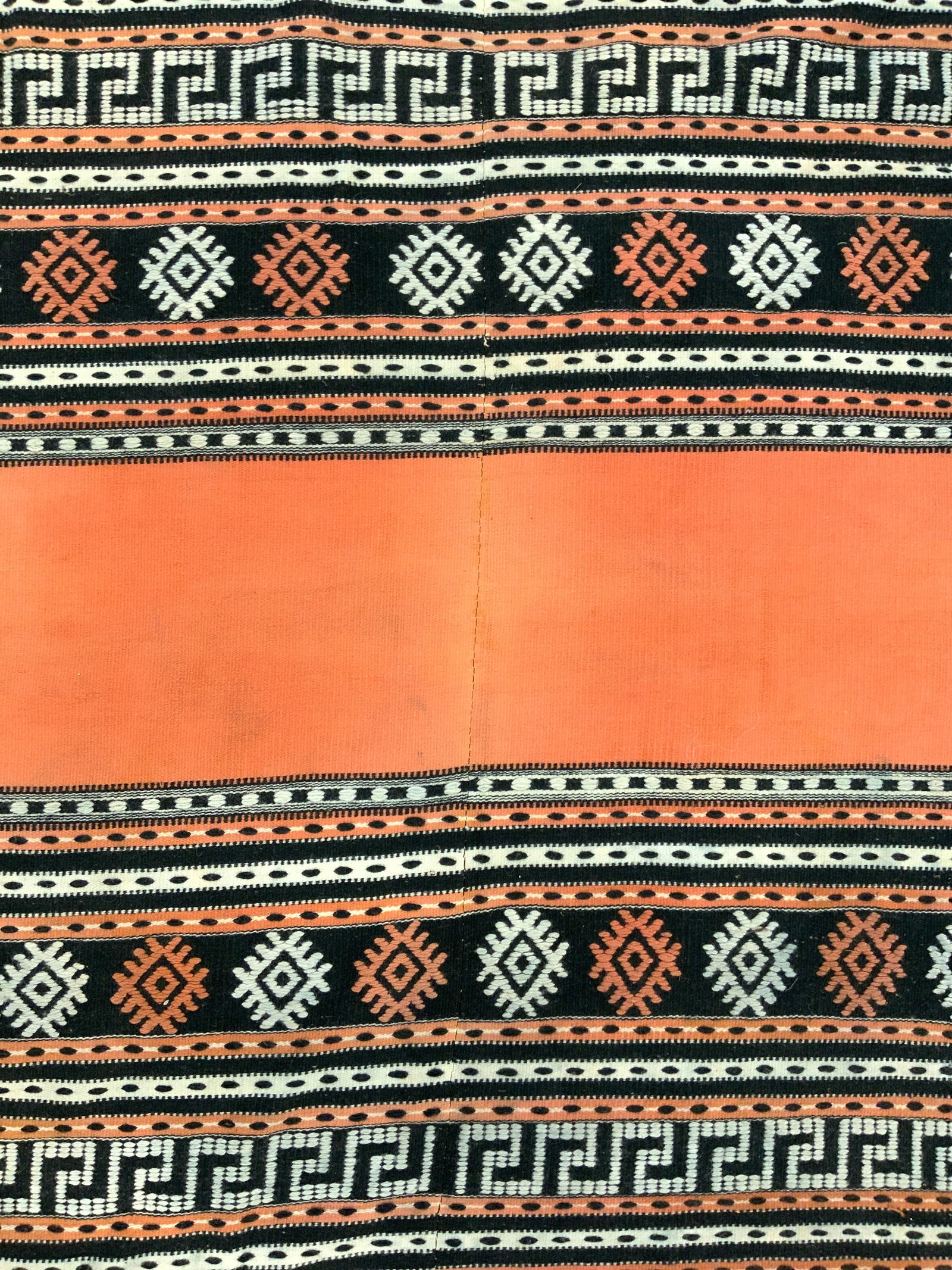 Vintage Handmade Fringed Turkish Kilim Wool Rug: Rug is handmade & wool. Piece is vintage. Rug appears to be Turkish Kilim. Piece has multi toned geometric detail. Edges of rug have knotted cream toned fringes. Rug measures approximately 83 inches l