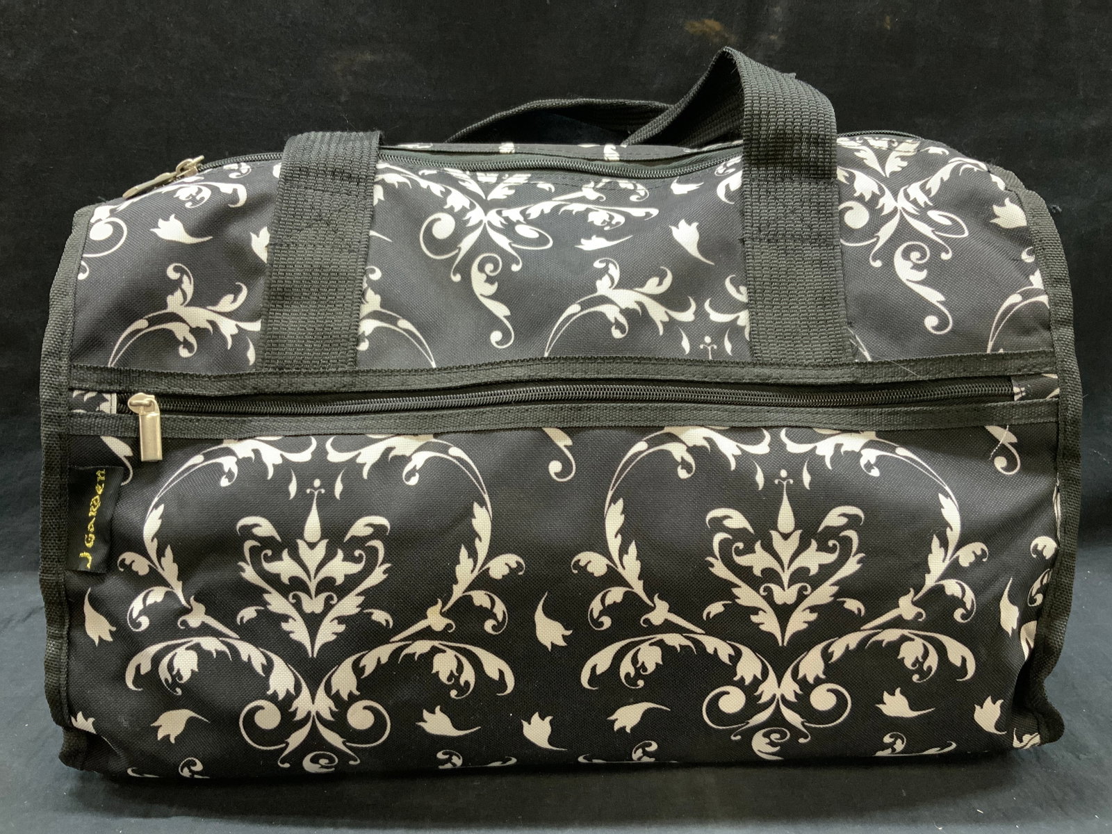 J Garden Paisley Duffel Bag: Marked on tag j.garden. Black and white paisley patterned duffel bag with canvass exterior. Approx 13 inches tall and 19 inches long and 8 inches wide. Moderate wearing to exterior and to zippers. J g