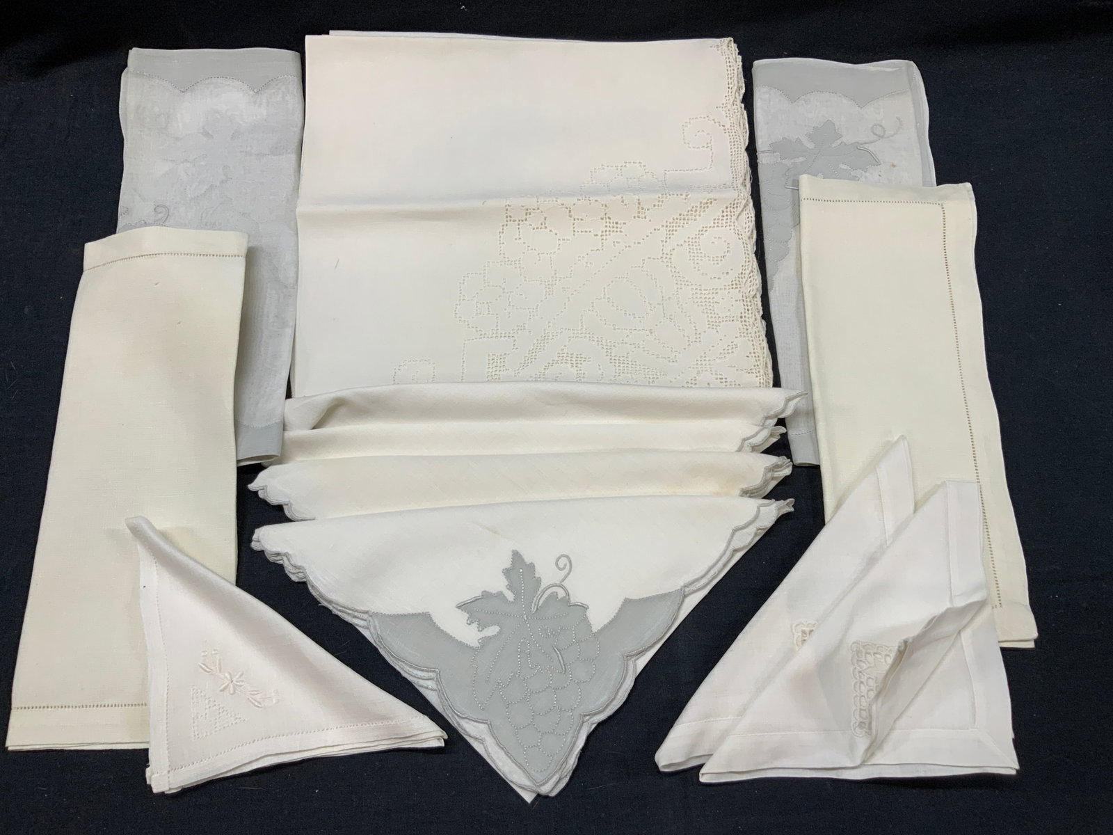 Lot 14 Lace & Embroidered Linens: Lot of 14 assorted linens. 1 set of off white linens with gray appliqu?s with floral and grape motifs, approx 16 x 16 inches. Set of 3 lace corner linens, approx 20 x 20 inches. 3 off white linens wit