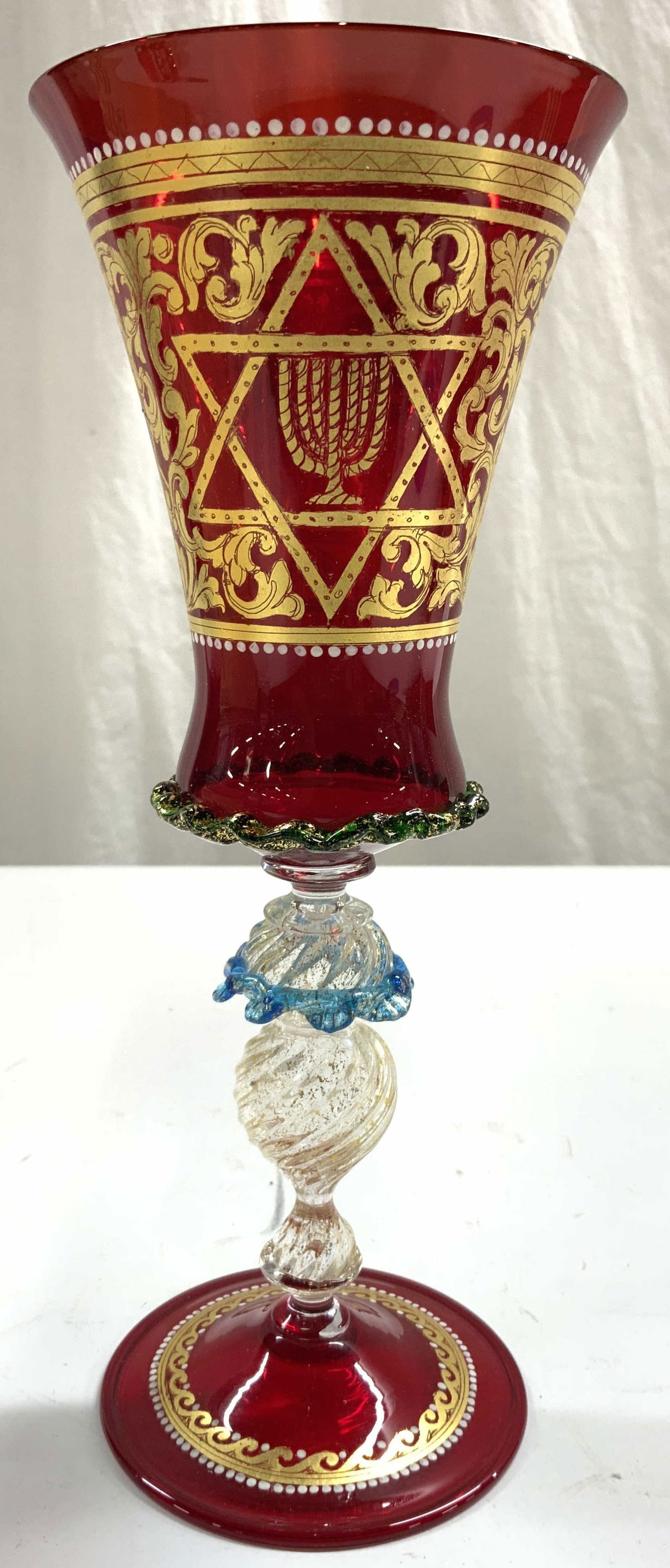 MURANO Vintage Judaica Art Glass Chalice W Box: Chalice appears to be MURANO glass (no apparent markings). Includes wooden box. Vessel is red and clear stem with gold fleck detail, red toned circular shaped base. Piece also has intricate ornate gil