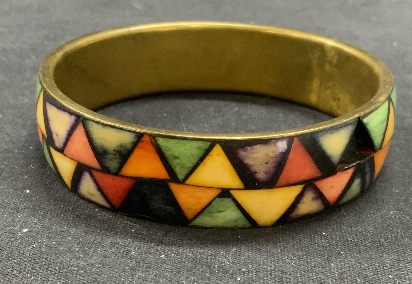 Vintage Geometric Bone Bangle Bracelet: Vintage geometric pattern bangle bracelet. Possibly dyed multi color inlaid bone. Measures approx. 2.5 inches wide. Some scratching observed. Some pieces need replacement. Estate jewelry, costume jewe