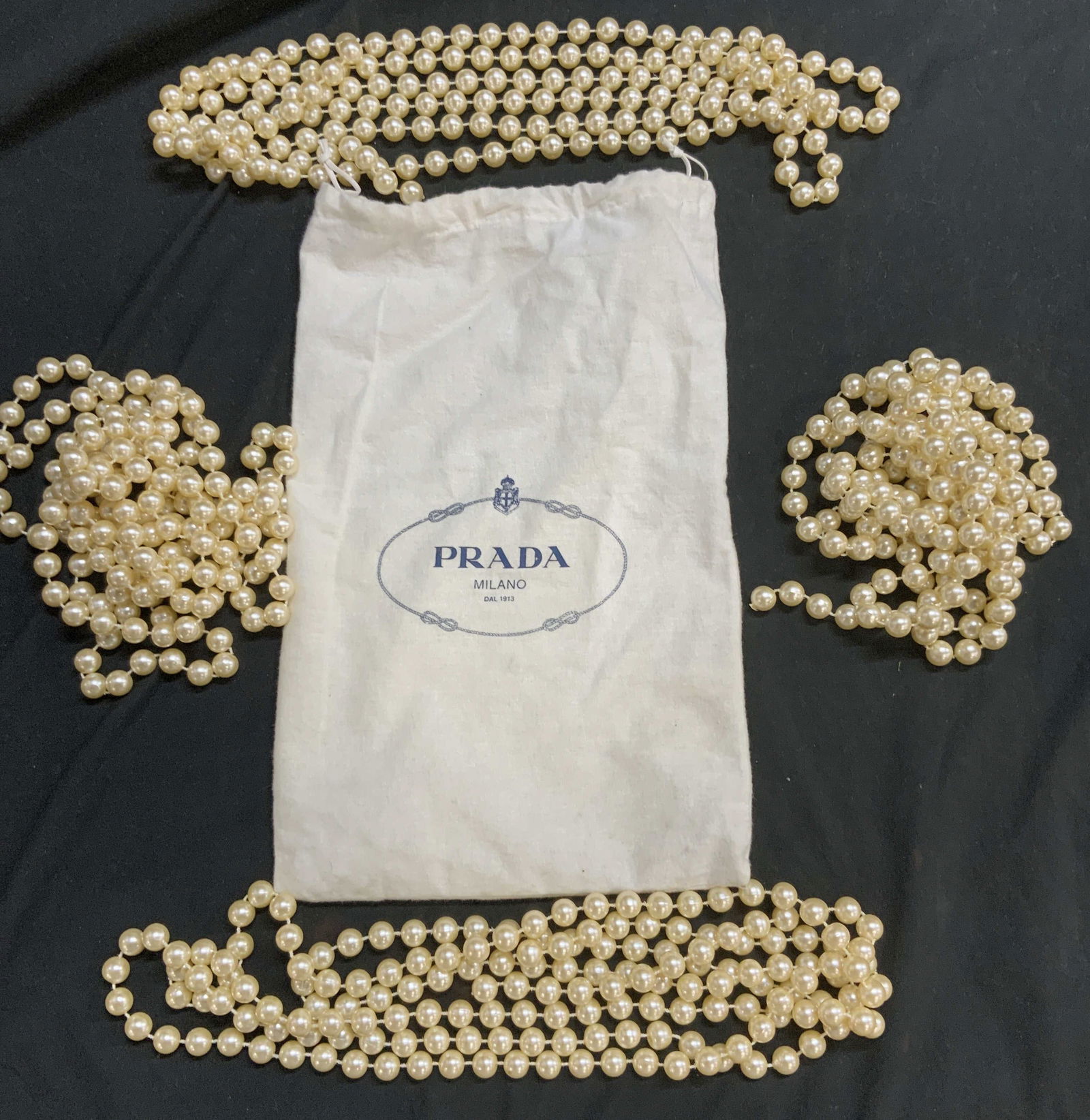 5 Prada Milano Dust Bag, Faux Pearls Tie Backs: White Prada Milano felt shoe dust bag with cinch rope, 13.5 x 8.5 in. 4 long Champaign faux pearl curtain tie-backs, 96 in. Long. Can be used for anything , including making a costume jewelry necklace