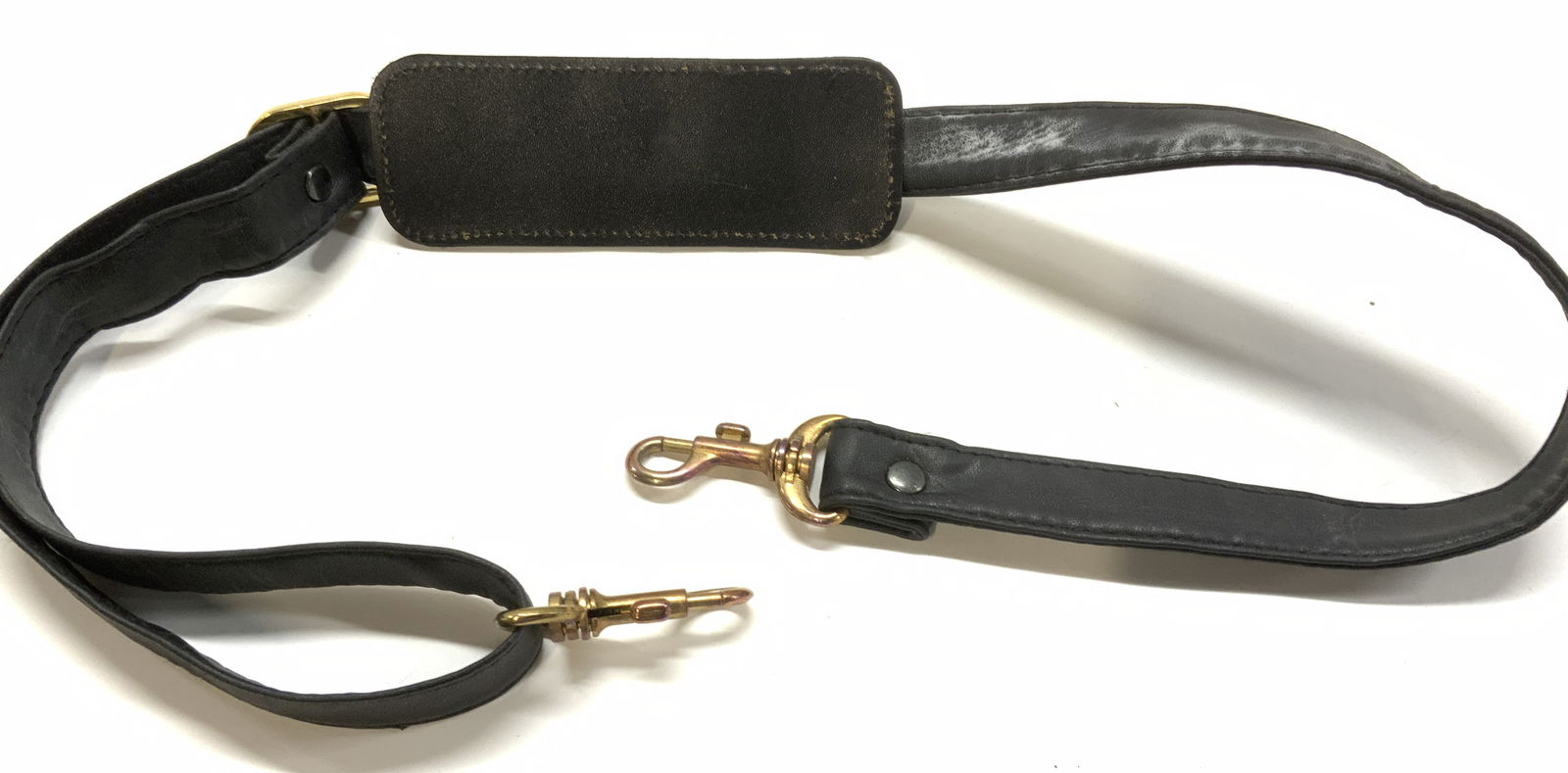 CHANEL France Signed Shoulder Strap w Hooks: Adjustable length Chanel Shoulder strap for travel luggage. Leather style . Measures 45 in. Lord with large end metal hooks and a canvas shoulder pad for comfort. ( 5.5 x 2 in.) Reads CHANEL MADE IN F