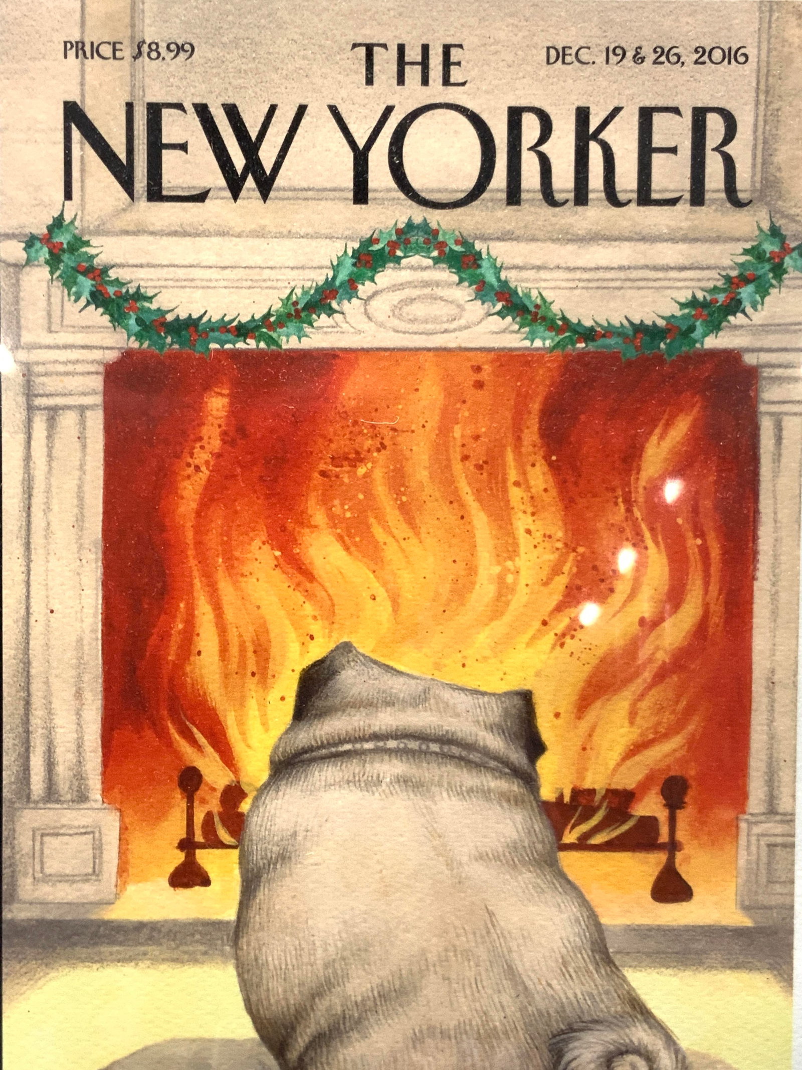 The New Yorker Christmas Fireplace 2016 Litho: Front page art of The New Yorker, marked 2016 Depicts a pug on a cushion in front of a fireplace with garland on it. Framed in a black coated wooden frame. Approx 14.5 x 11.5 inches window measures 11