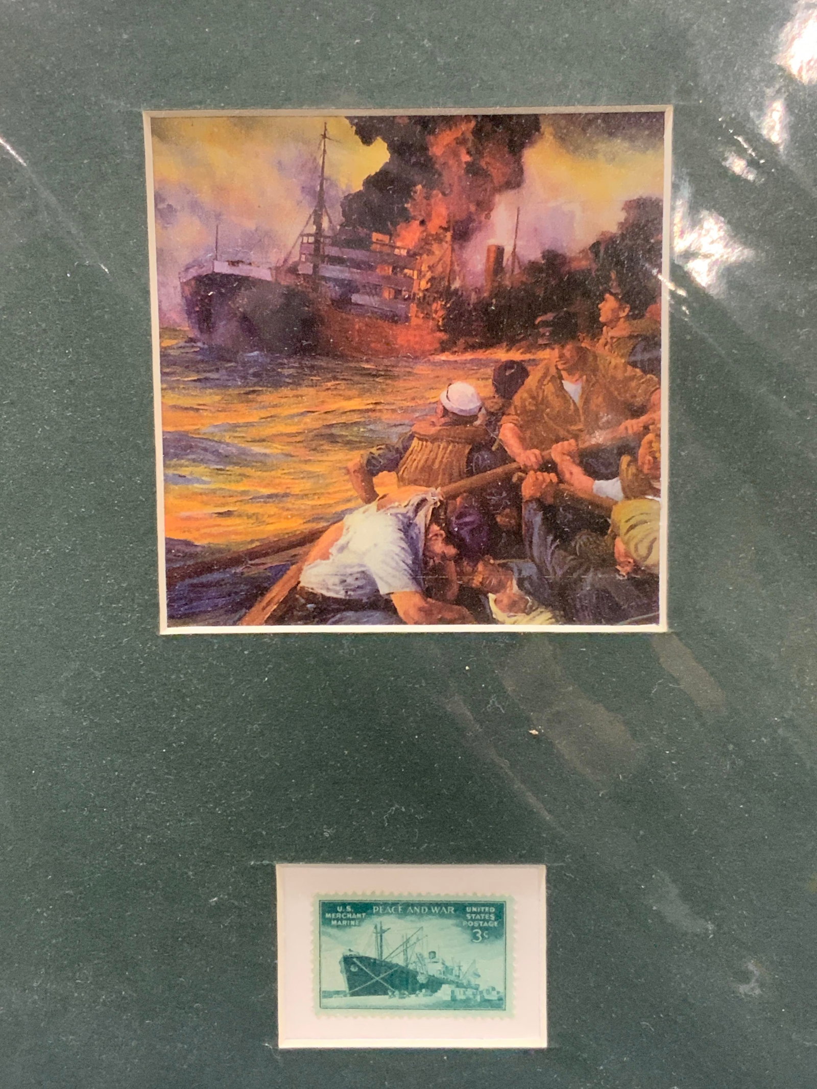 A Careless World Litho & 3cent Stamp: A green mat board with a lithograph of a ship on fire with men fleeing the ship, originally marked on litho, a careless world, a Needless Sinking. Underneath the lithograph is a vintage green toned 3 
