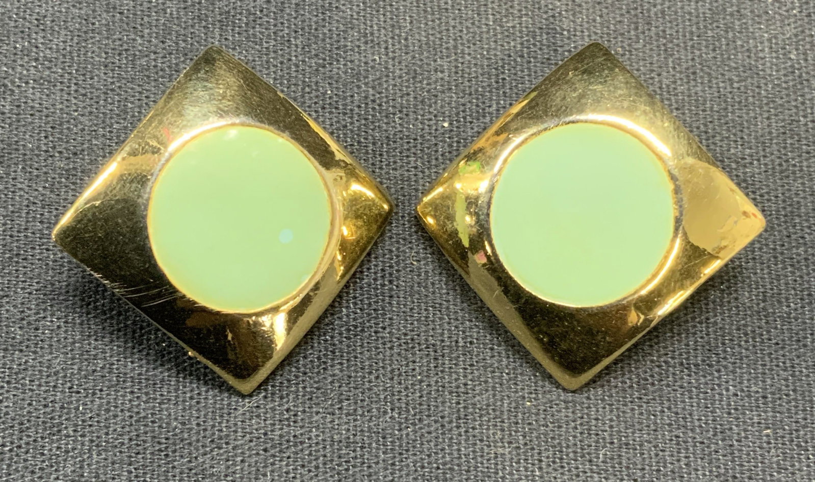 Vintage Polcini Gold Tn Blue Enamel Earrings: Vintage Polcini gold tone diamond shale earrings with blue enamel circle decoration. Clip on backing. Signed to backing. Measure approx. 1.25 x 1.25 inches. Some scratching observed. Estate jewelry, c