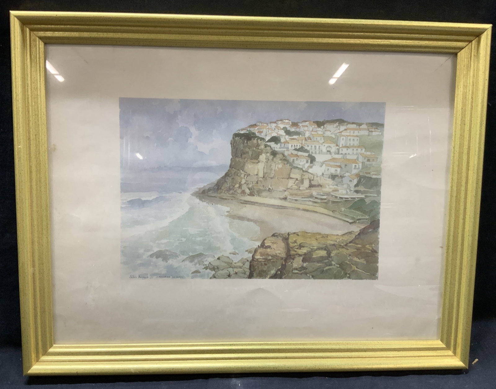 Julio Amaro Azenhas do Mar Portugal Litho: Marked on corner Julio Amro Azenhas do Mar, depicting the coastal town with a Rocky Mountain side of the ocean. Framed in a gold leafed wooden frame. Approx 13 x 17.6 inches and window measures 11 x 1