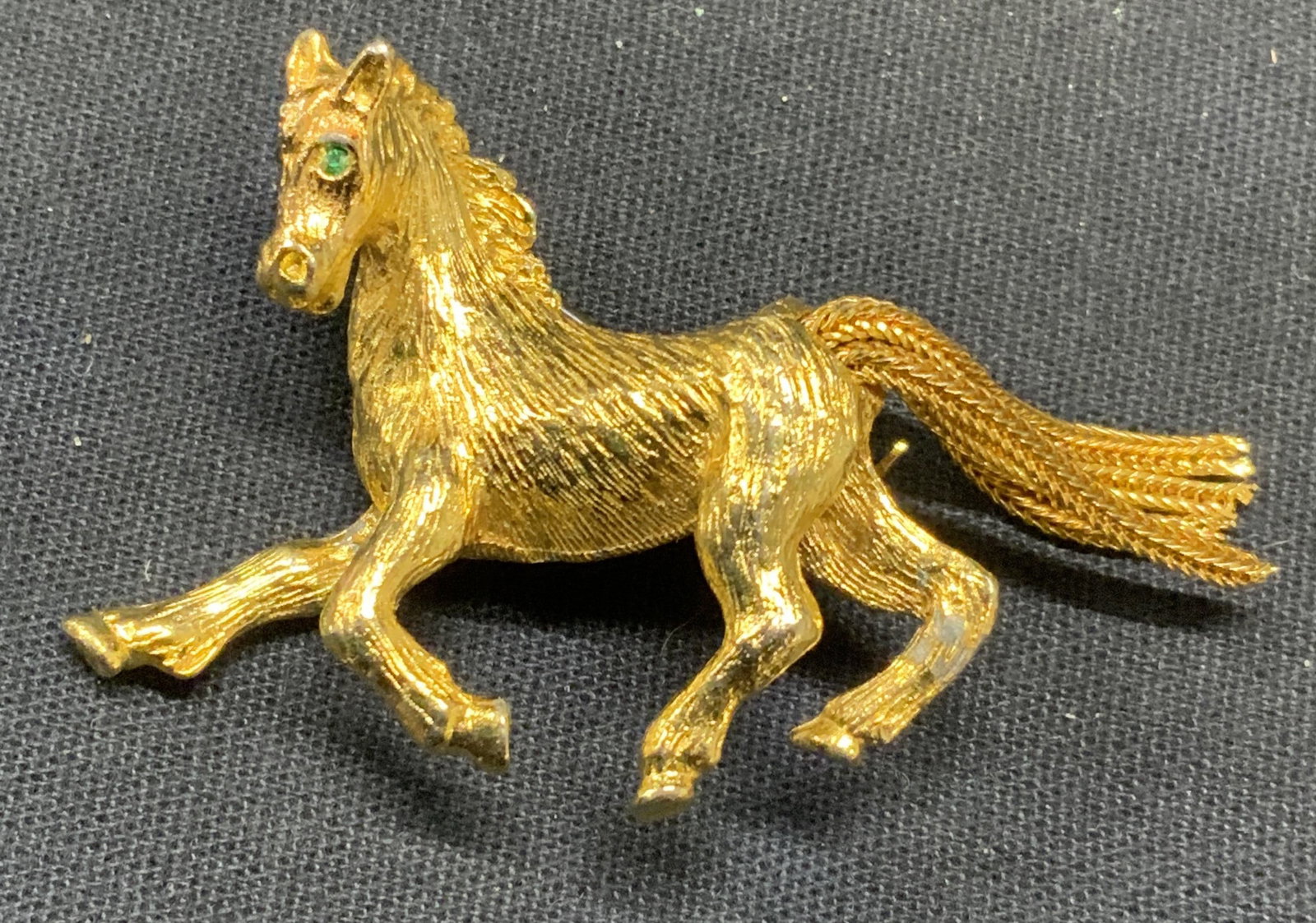 Vintage Gold Tone Equestrian Horse Brooch: Vintage gold tone equestrian horse form brooch with moving chain tail detail. Hinge pin to underside. Measures approx. 1.25 x 1.75 inches. Some scratching observed. Estate jewelry, costume jewelry, co