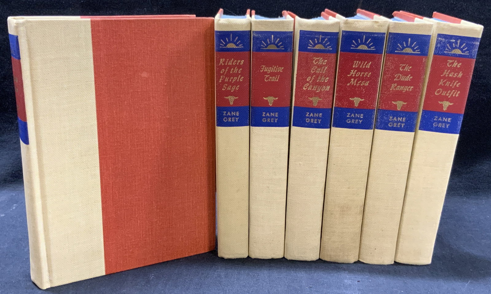 Zane Grey 8 Volumes Walter J Black 1940: Lot of 8 books of Walter J Black published books by Zane Grey. copyright 1940- 1961 punished by Walter J Black. Books bound by tan and red toned canvas covers with blue and gilt text on spines with st