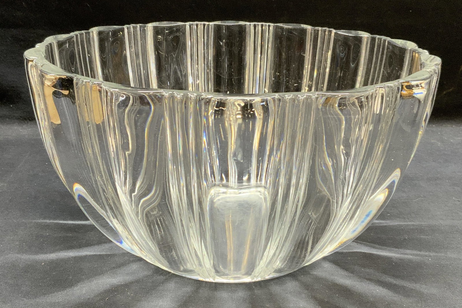 Ribbed Glass Bowl, 11 Inches Wide: Glass bowl with ribbed design. Thick walled glass, piece has weight. Measures approx. 11 x 5.5 inches. Some scratching observed. Glass bowl, bowl, ribbed bowl, centerpiece bowl, tableware, table acces