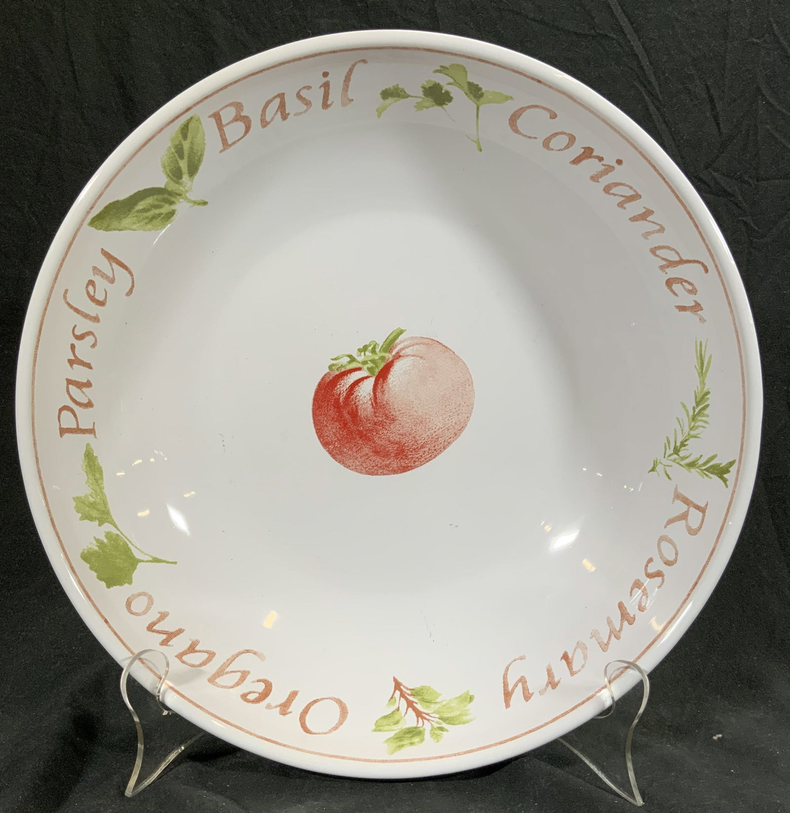 Porcelain Bowl Vessel W Tomato & Herbs: Bowl is porcelain. Center of interior has image of tomato, names and images of herbs PARSLEY, OREGANO, BASIL, CORIANDER, ROSEMARY. Bowl is white toned. Piece measures approximately 13 inches diameter 