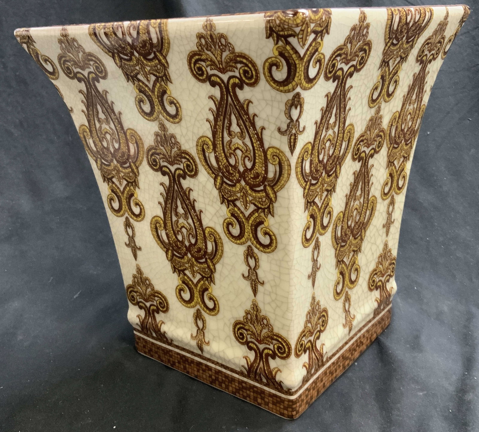 Hand painted Mughal Pattern Porcelain Planter: 10 in. tall flared square porcelain planter with hand painted Mughal scroll pattern. Cream with glaze crazing , pattern in brown and yellows. 9 x 9 in. Base is 6 x 6 in. Hallmarked on the underside. H