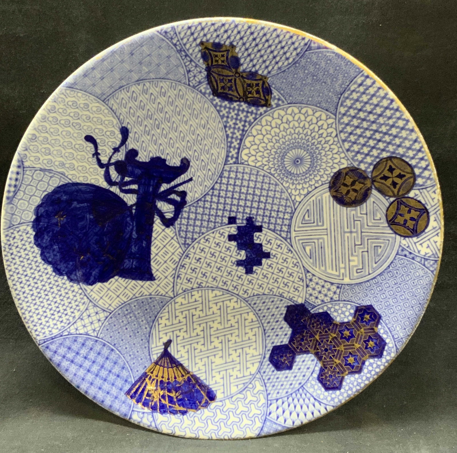 Worcester Tiffany & Co Chinoiserie Porcelain Dish: Marked on underside Royal Worcester, made for Tiffany & co. Porcelain dish with Asian style patterns in blue and gilt motifs of Asian fans. Approx 9 inch diameter. Moderate wearing to gilt edges and d