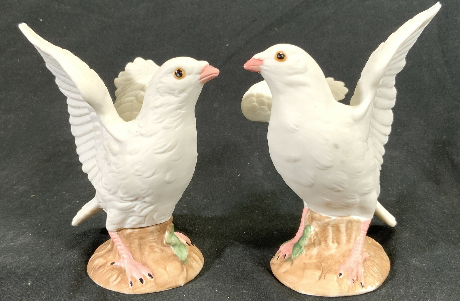 Lot 2 Vintage Porcelain Dove Figurals: Lot includes 2 dove figurines. Each are vintage and porcelain. Each depict dove figures with wings spread. Figures each have relief detail give feather detail. Largest piece measures approximately 5 i