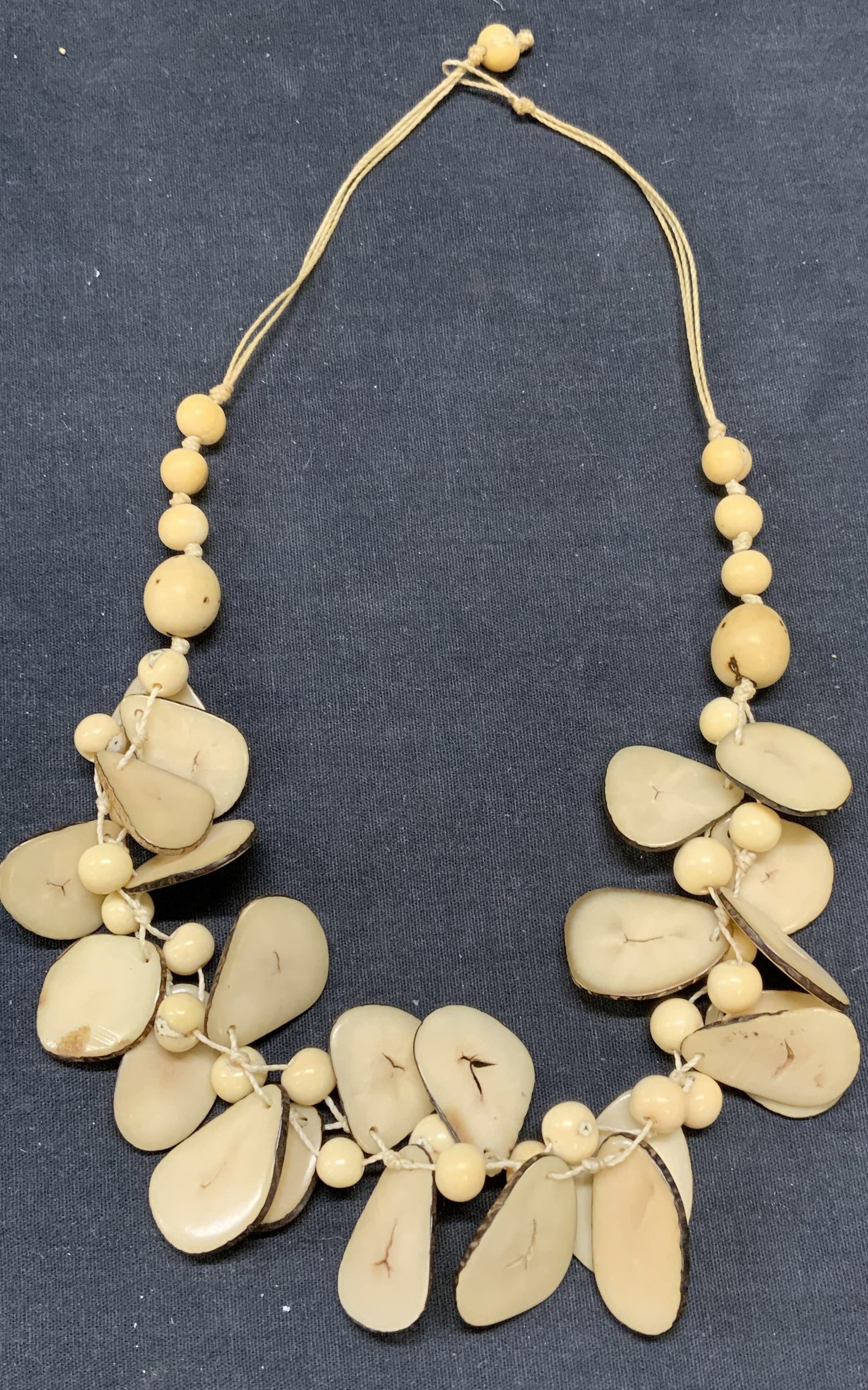 Vintage Handmade Natural Beaded Necklace: Vintage handmade round and disc beaded necklace. Natural material, possibly bone. Drop length approx. 10 inches. Some scratching observed. Estate jewelry, costume jewelry, cocktail jewelry, fashion je