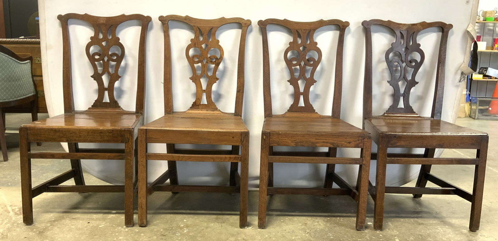 Set4 Antique Carved Wood Chippendale Dining Chairs: Chairs are antique. Each chair is brown toned carved wood, Chippendale style with vase form backrest. Chairs each have box stretcher in between legs. Each measures approximately 38 inches tall 19 inch