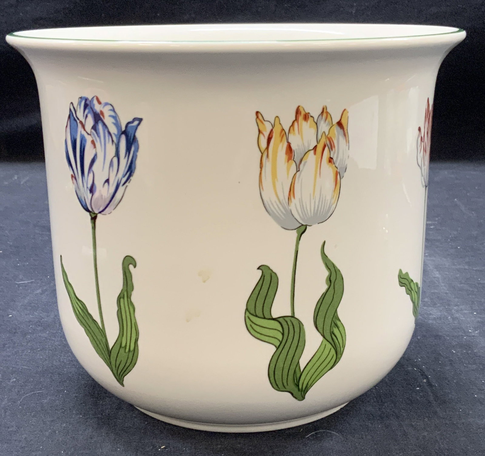 Tiffany & Co Porcelain Tiffany Tulips Vessel: Marked on underside Tiffany tulips, designed by and made exclusively for Tiffany & co. White porcelain planter with colored tulips on exterior. And rim lined with green. Approx 5.5 inches tall and 6.7