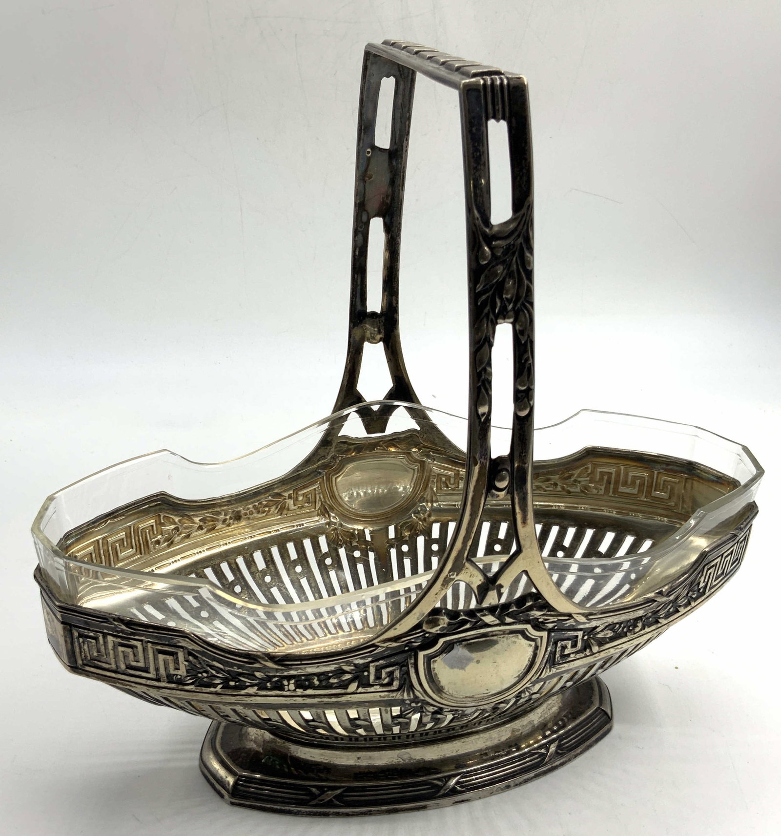 R.R Stamped 800 Silver Embossed Boat Basket: Stamped on underside, 800 R.R.A silver embossed basket with top handle, resembling the shape of boat. Embossed with shields on either side and cut outs on lower half of basket. Top handle has floral m