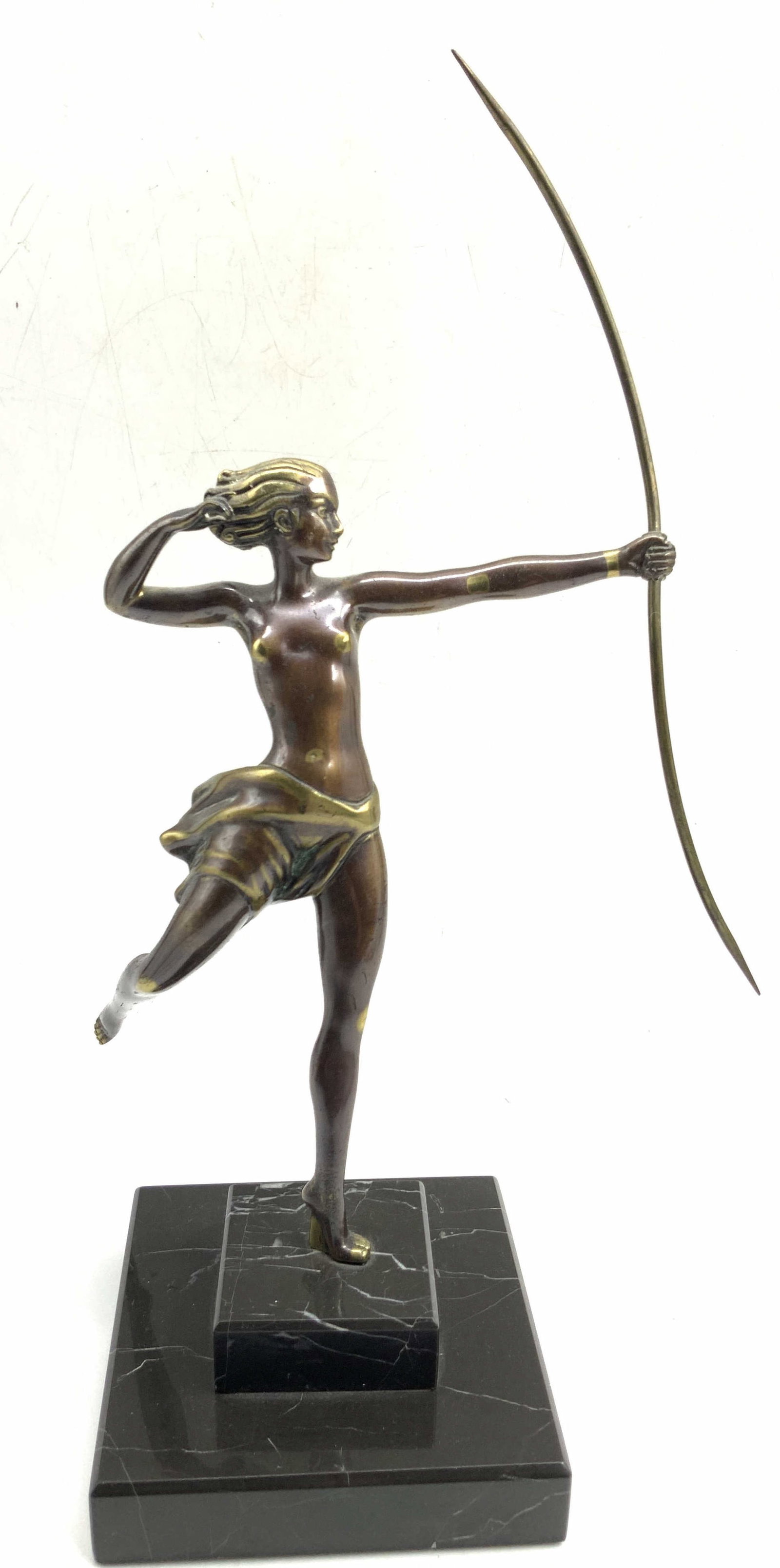 Gilt Bronze Archery Woman On Marble: Gilt bronze, possibly patina brass figure of a woman with a long bow, mounted by one footed to a black marble base. Approx 13 inches tall and base being 4.25 x 4.25 inches wide. Gilt metal observed on