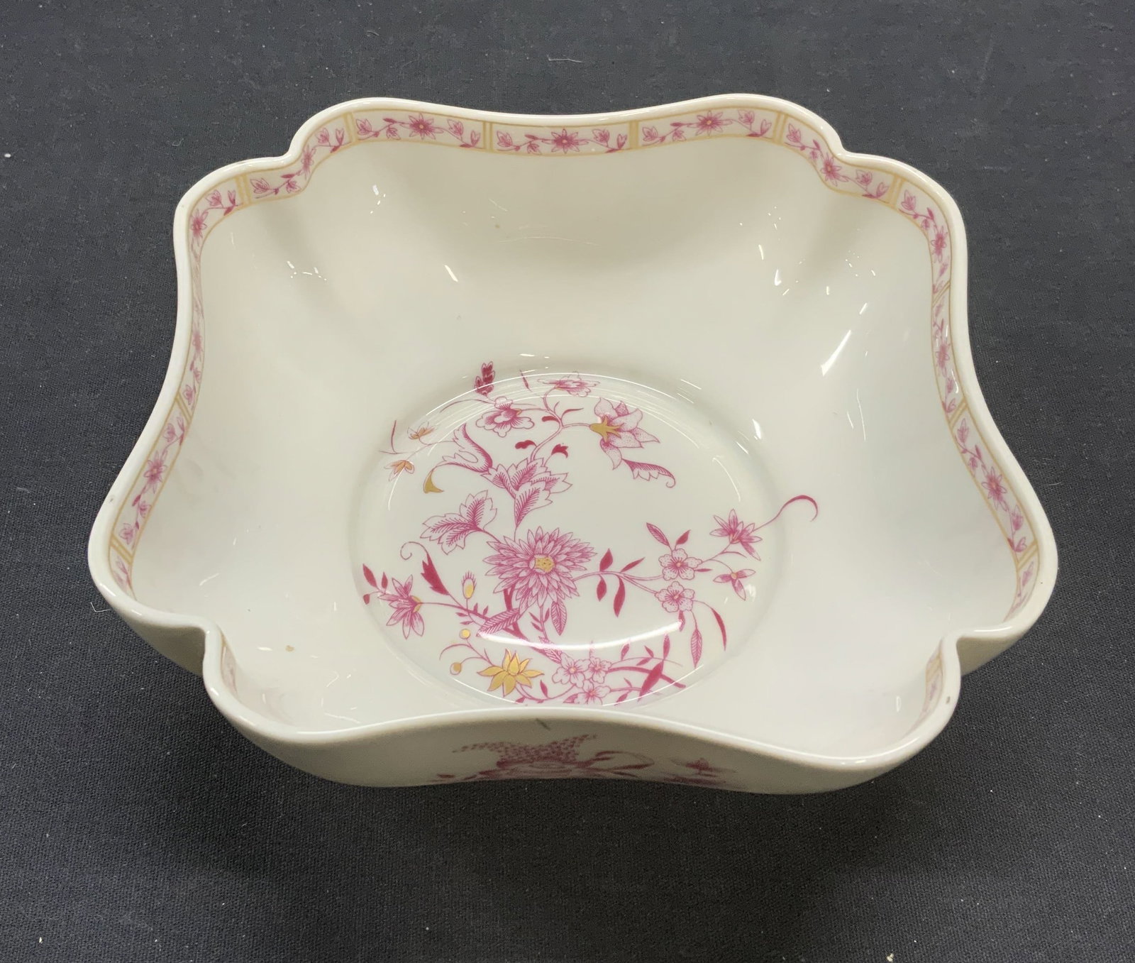 A. Vignaud Limoges Porcelain Bowl, France: Vintage A. Vignaud Limoges square shaped porcelain bowl. White and pink with floral motif and gilt decoration. Trademarked to underside. Made in frame. Measures approx. 6.5 x 2.25 inches. Some scratch