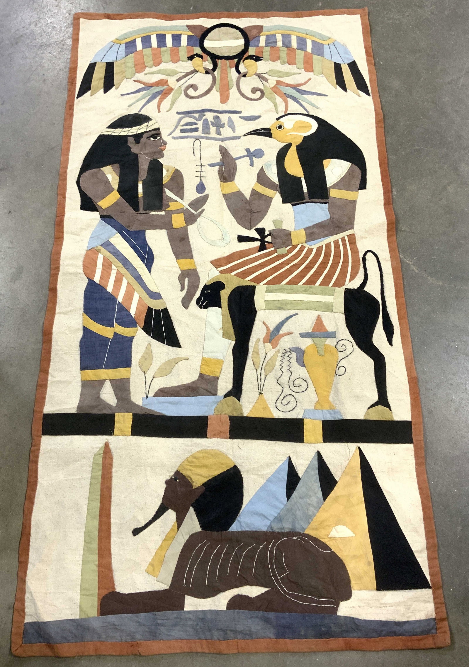 Hand Sewn Egyptian Applique Wall Tapestry: Applique hand crafted wall tapestry on heavy cotton backing. Egyptian Pharaoh, Monkey , Sphinx , Great pyramids , and pharaoh wearing a penguin headdress. All hand sewn Applique . Long wall tapestry. 