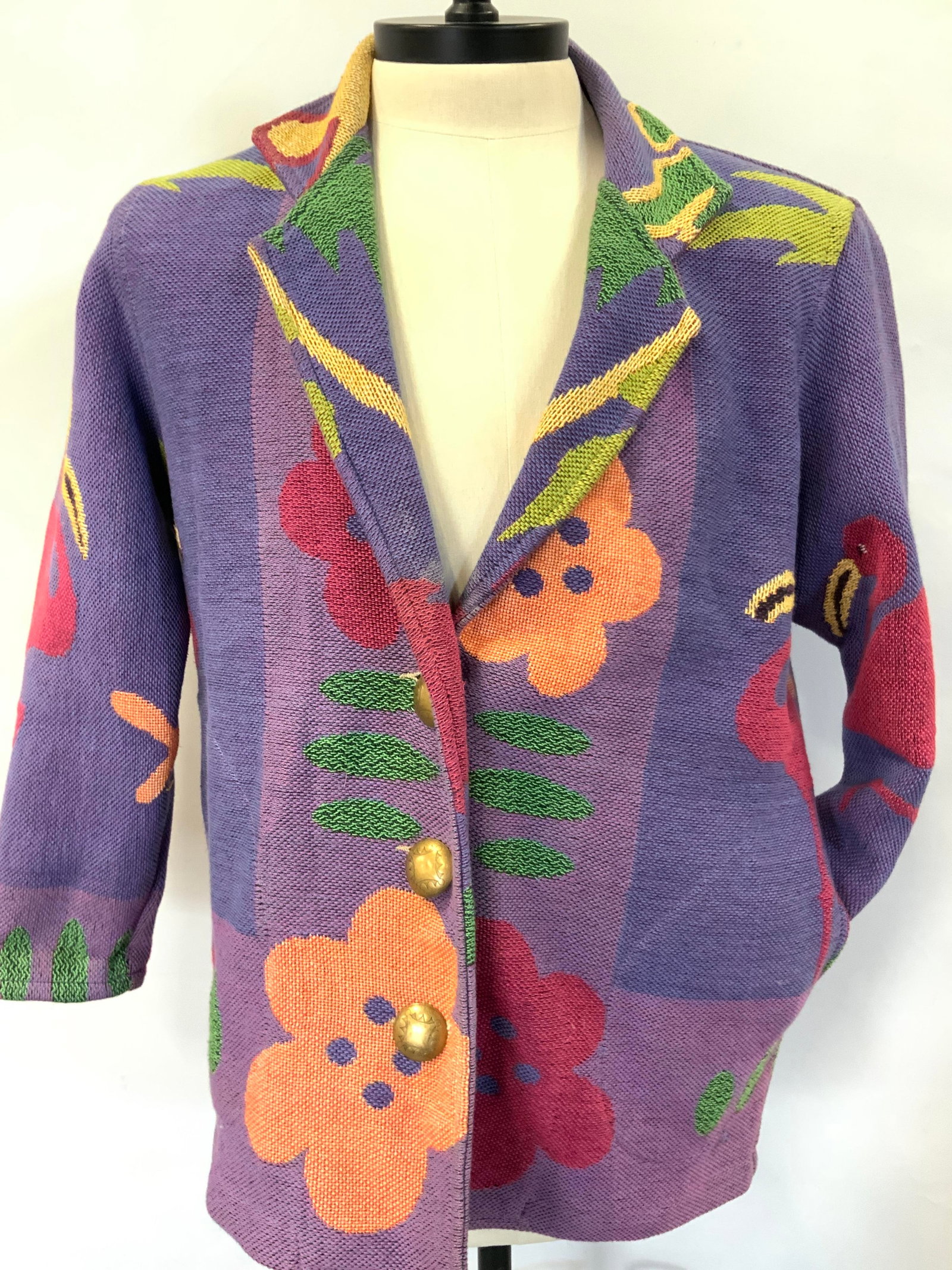 Painted Pony Flamingo Cotton Blazer Jacket: Tag marked painted pony, Woven cotton blazer jacket with woven images of tropical flowers and pink flamingos throughout jacket, two front pockets and etched brass buttons. Sleeves measure 14, chest me
