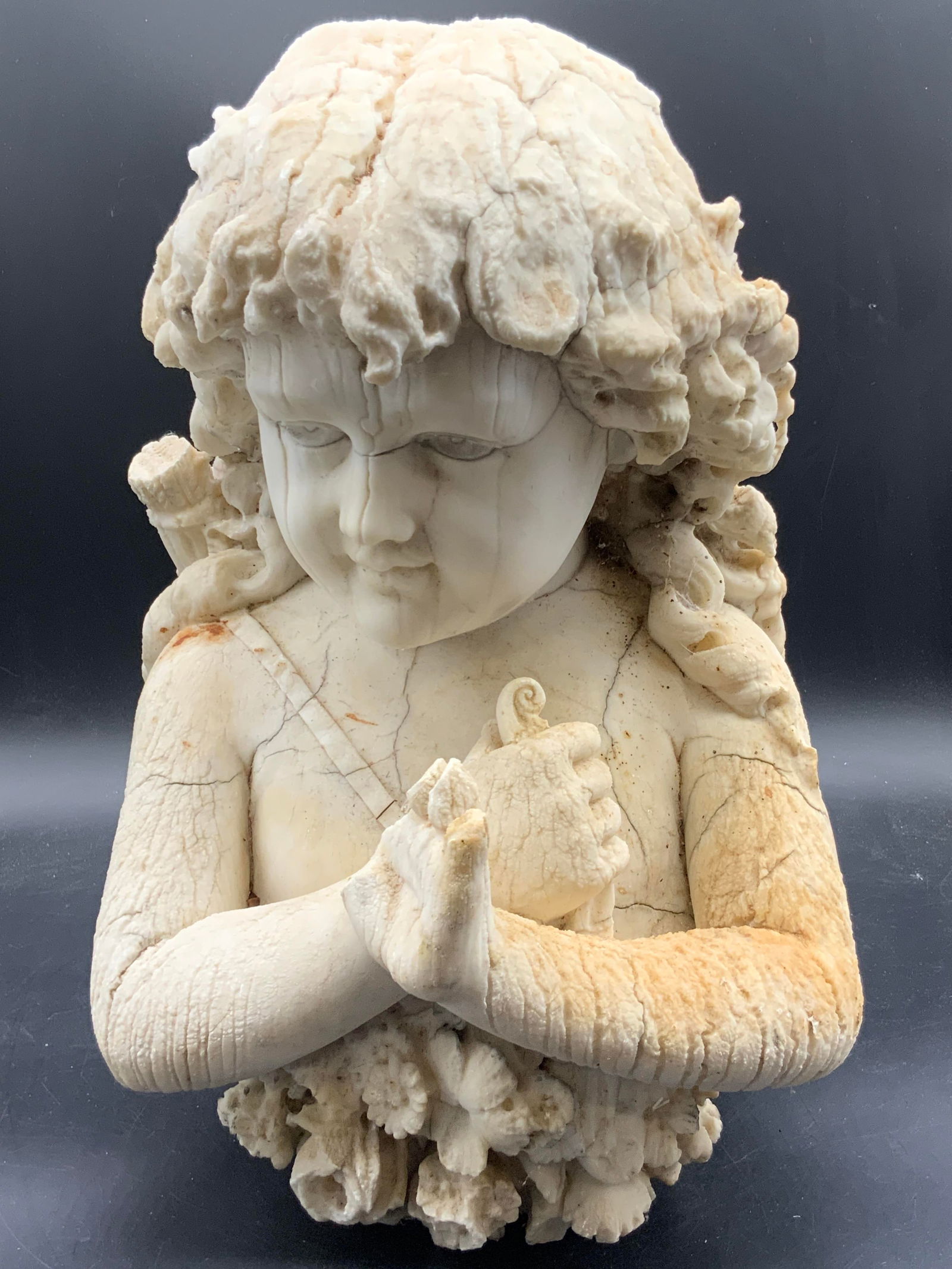 Vintage Alabaster Stone Female Figure Statuary: A vintage alabaster stone female figure statuary. Raised and etched details. Florals towards the base. Weighty piece. Measures approx. 15.5H x 10W in. Evident losses, cracking, discoloration, and surf