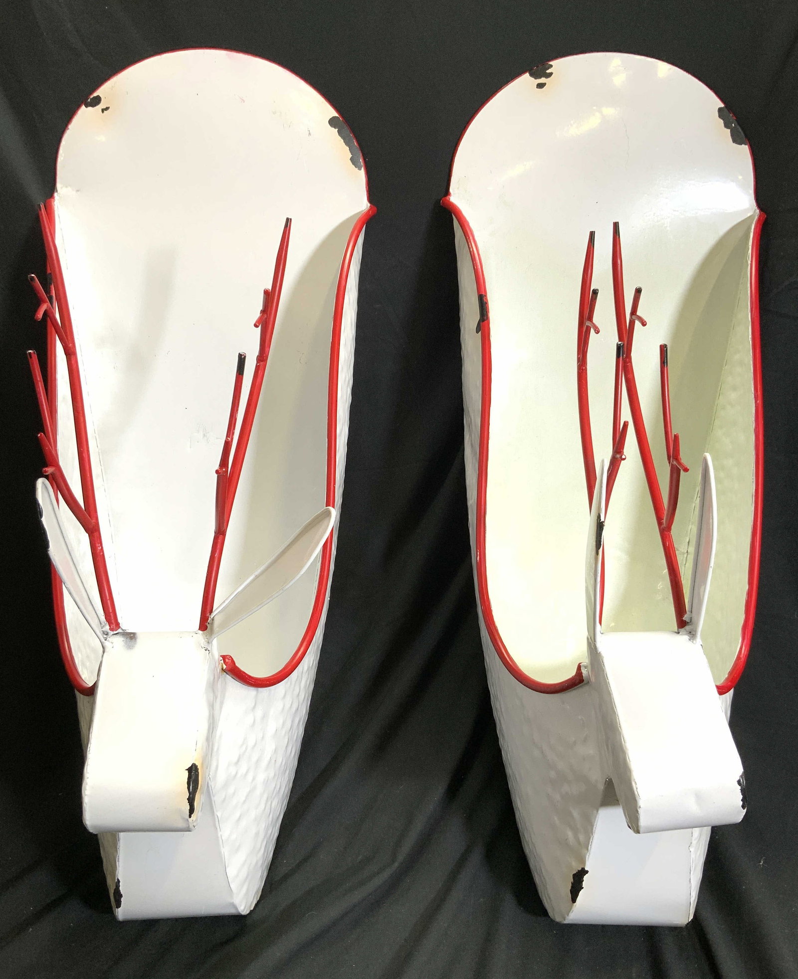 Pair Metal Reindeer Wall Pockets: Lot includes 2 wall pockets. Each are white with red toned accents. Wall pockets each have reindeer head forms with antlers. Each wall pocket measures approximately 30 inches tall 13 inches wide 16 in
