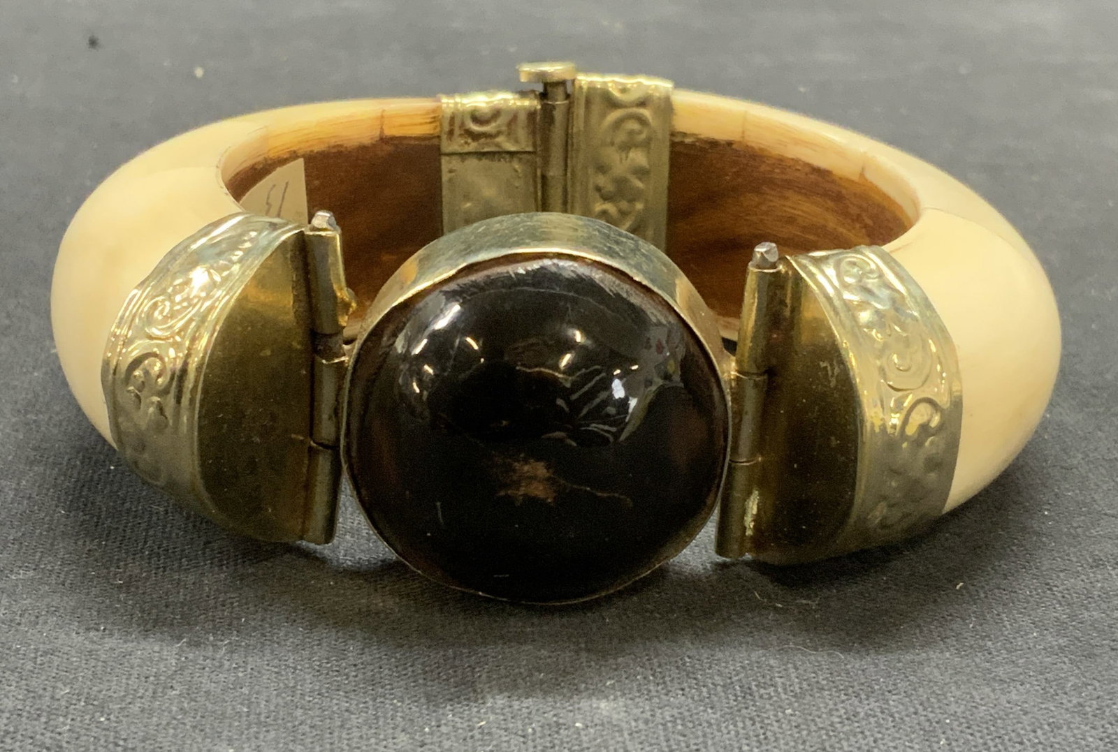 Tessellated Bone Black Cabochon Bracelet, India: Tessellated bone bangle bracelet with black cabochon and embossed silver tone metal detail. Made in India. Measures approx. 2 3/8 inches wide. Some scratching observed. Estate jewelry, costume jewelry