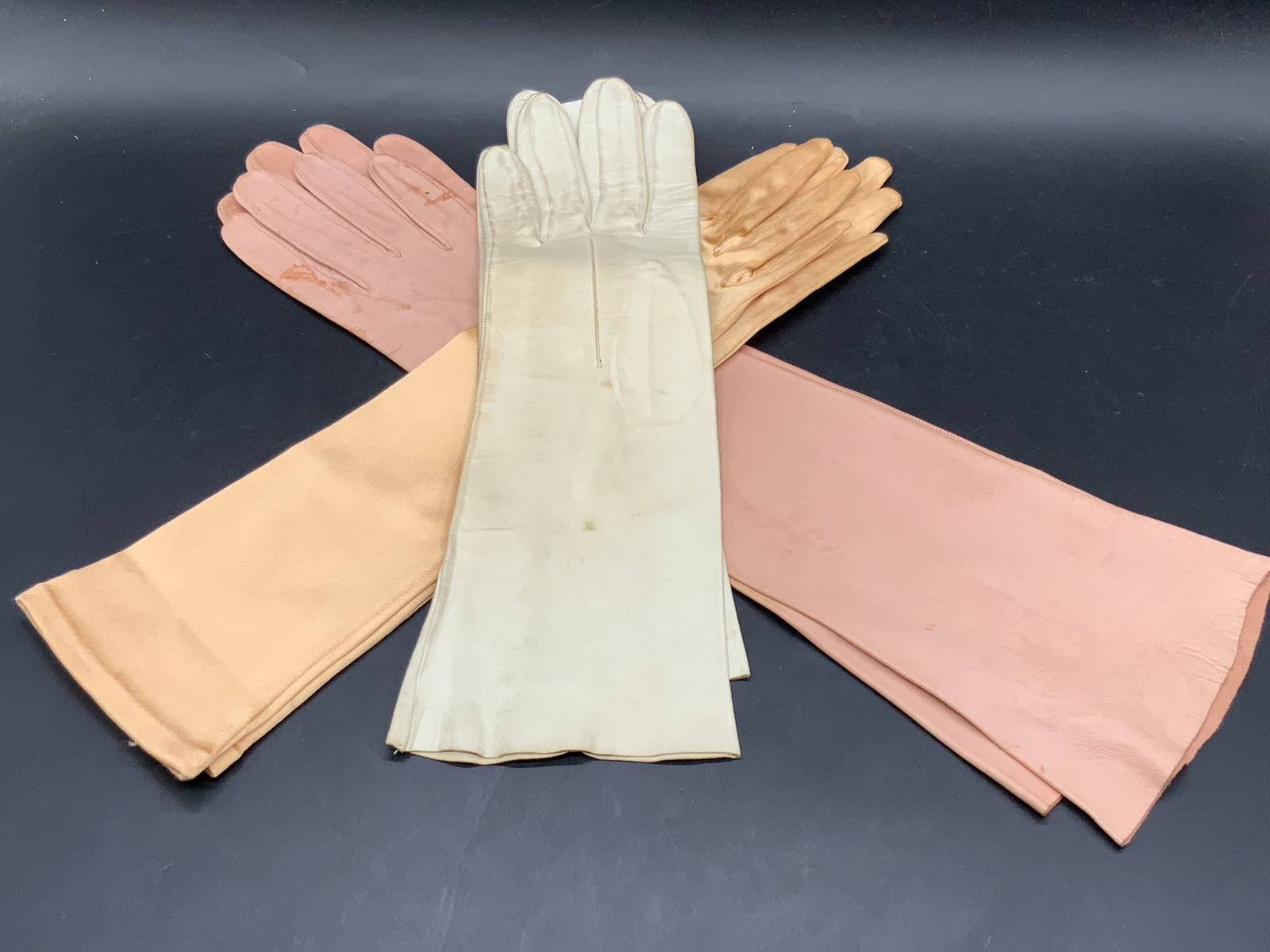 Lot 3 Vntg Long Gloves, BRYANS GLOVES & More: Three pairs of vintage long gloves. Pieces are crafted from leather and satin style material. Light neutral hues. One interior marked BRYANS GLOVES MADE IN WORCESTER. Longest gloves measures approx 17