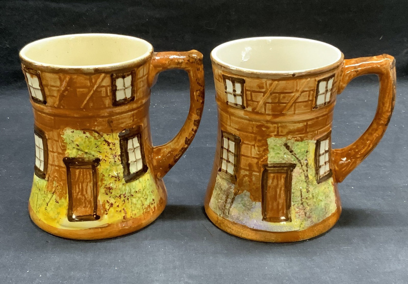 Lot 2 Vtg Price Bros Cottage Ware Cups England: Lot of 2 vintage Price Bros Cottage Ware ceramic cups. Hand painted with cottage motif. Trademarked to underside. Made in England. Measure approx. 4 x 4.75 inches each. Some wear to each including scr