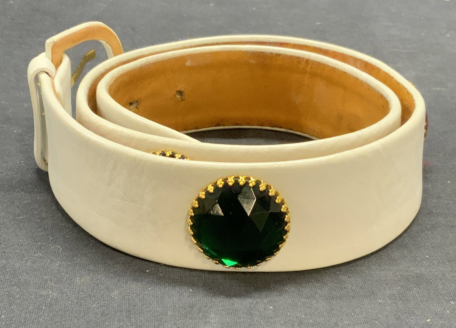 White Leather & Multi Color Crystal Belt: White leather belt with multi color crystal stud decoration. Measures approx. 31.5 inches long. Some wear to leather, scratching, and blemishes observed. Ladies belt, ladies leather belt, ladies white