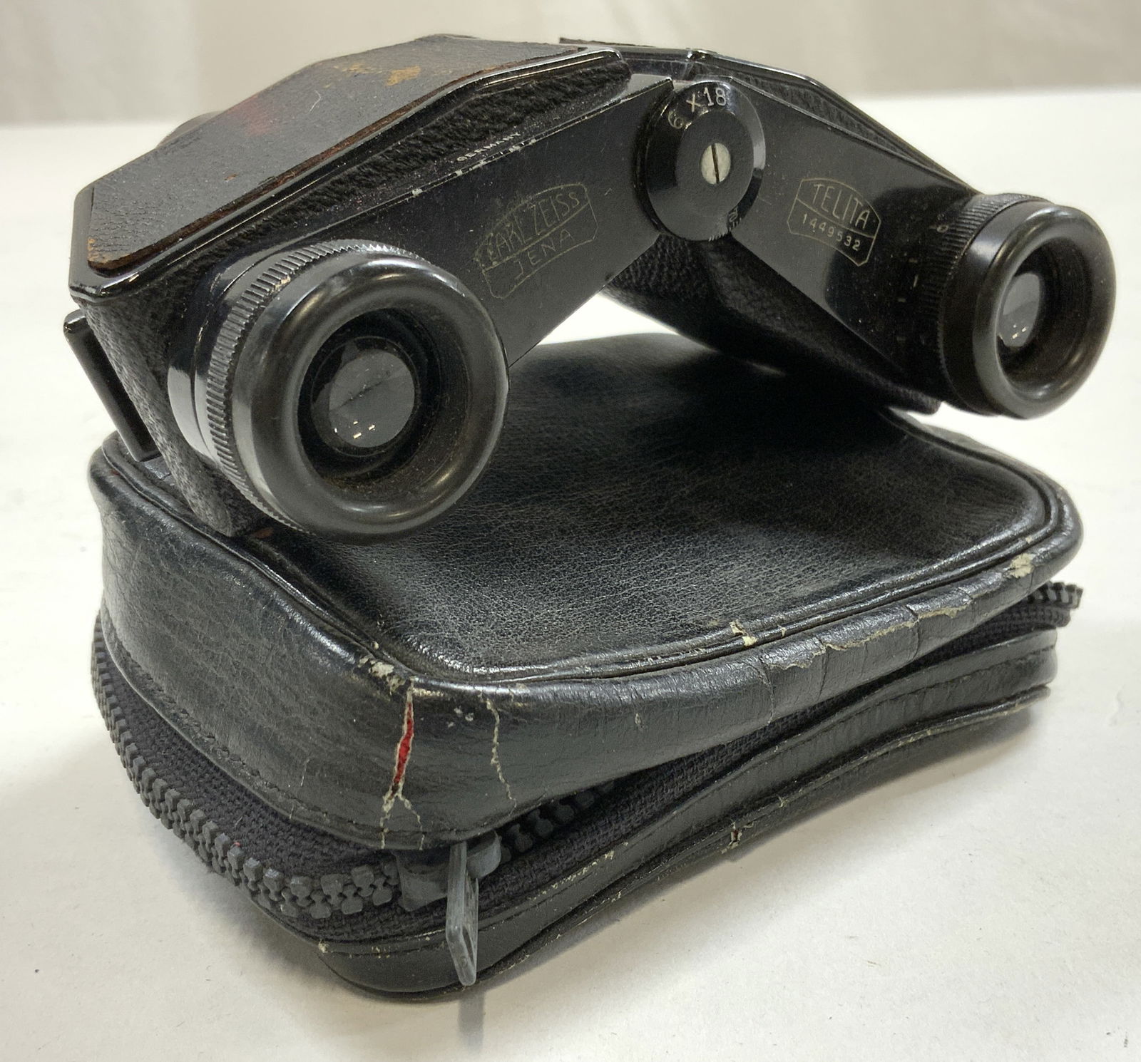 CARL ZEISS JENA Germany Binoculars & Case: Binoculars inscribed CARL ZEISS JENA TELITA 1449532 & marked for Germany. Binoculars are black toned, appear to be vintage. Lot also includes black toned leatherette zippered vase trademarked RICOH. B
