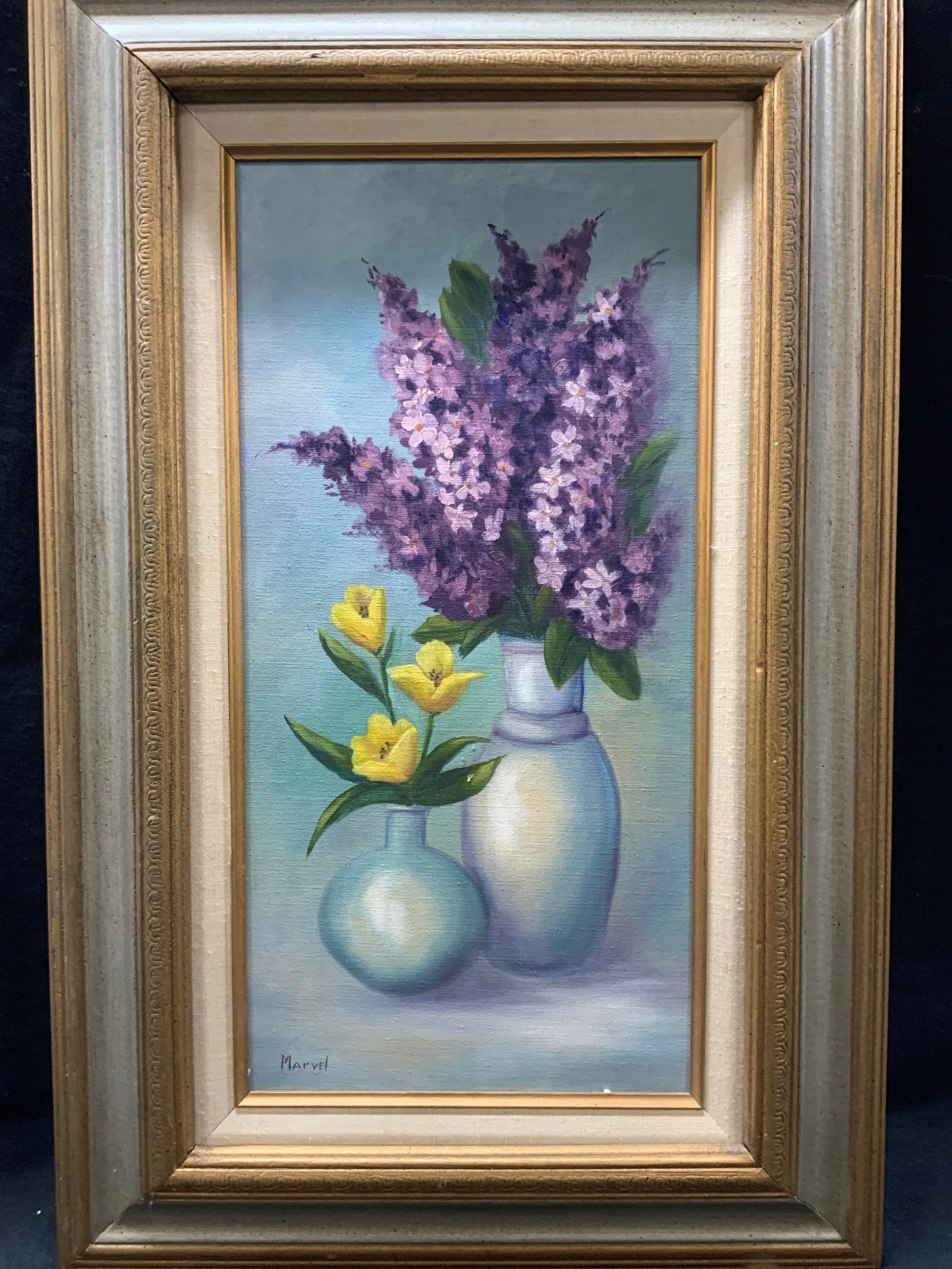 Marvel Sgd Still Life Oil Painting 2ft4in: Signed on lower left corner Marvel Depicts a still life of two vases with flowers Framed in gold and silver painted carved wooden frame Approx 28 x 18 inches window measures 19.5 x 9 inches. Moderate 