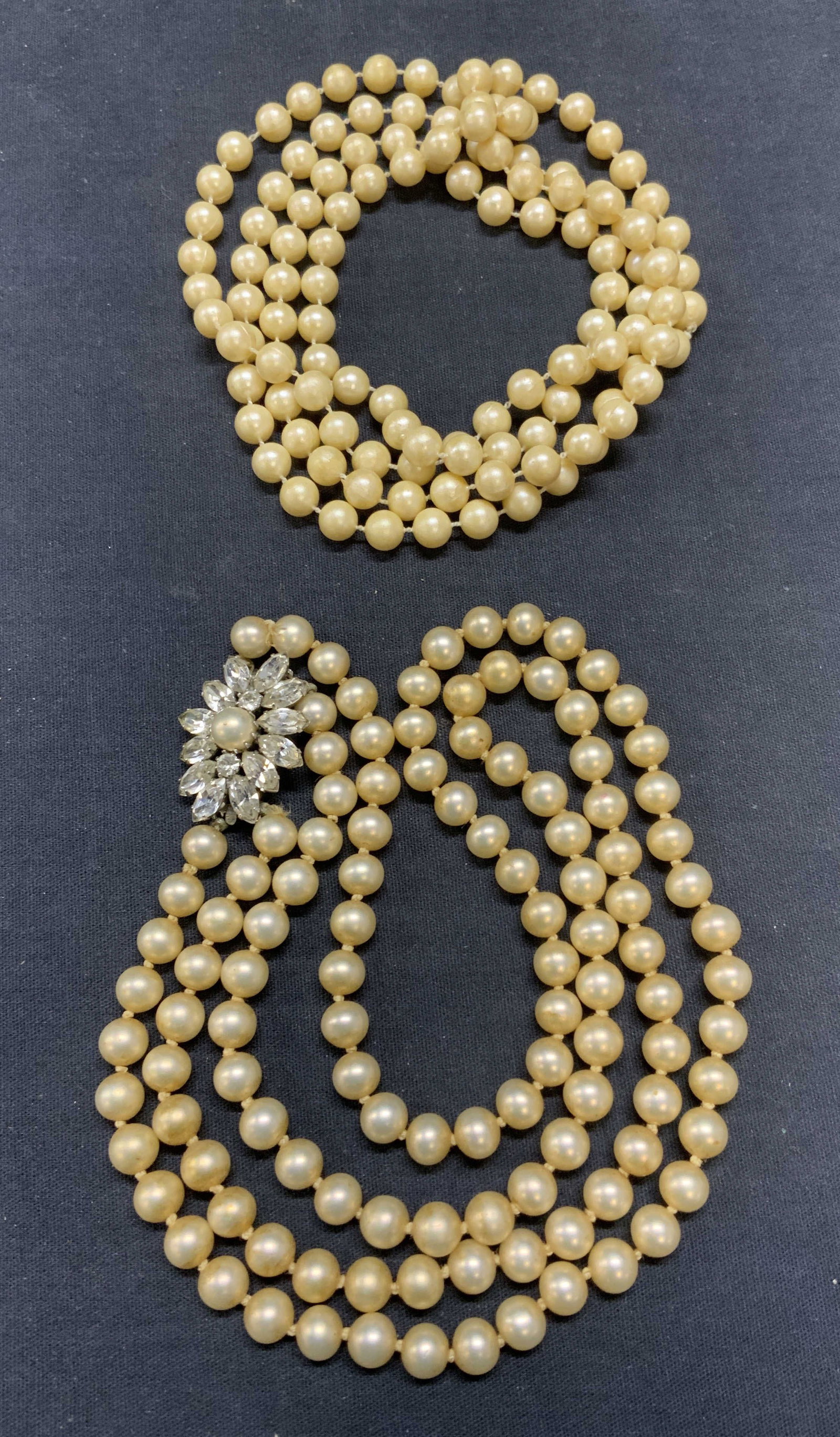 Lot 2 Vintage Faux Pearl Beaded Necklaces: Lot of 2 vintage faux pearl beaded necklaces. Double strand faux pearl necklace on double knotted string with crystal clasp. Drop length approx. 10 inches. Faux pearl rope necklace. Drop length approx
