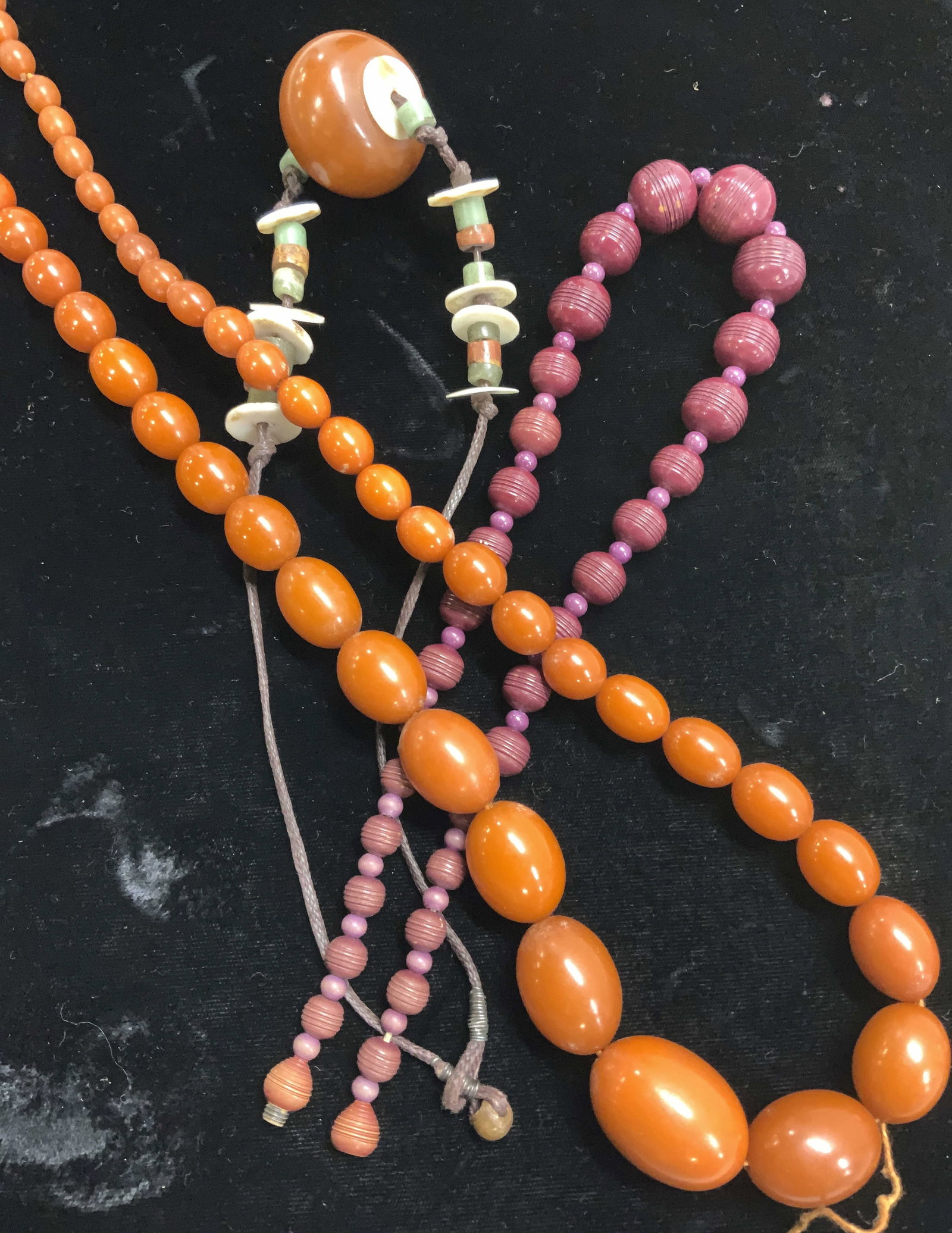 Lot 3 Fashion Bead Necklaces, Jewelry Making Beads: 2 choker necklaces, 1 hand crafted on cord with a large chunky center bead. Includes art glass beads. Drop is 6 in. Wine color plastic bead necklace with twist clasp, drop is 7 in. Long burnt orange c