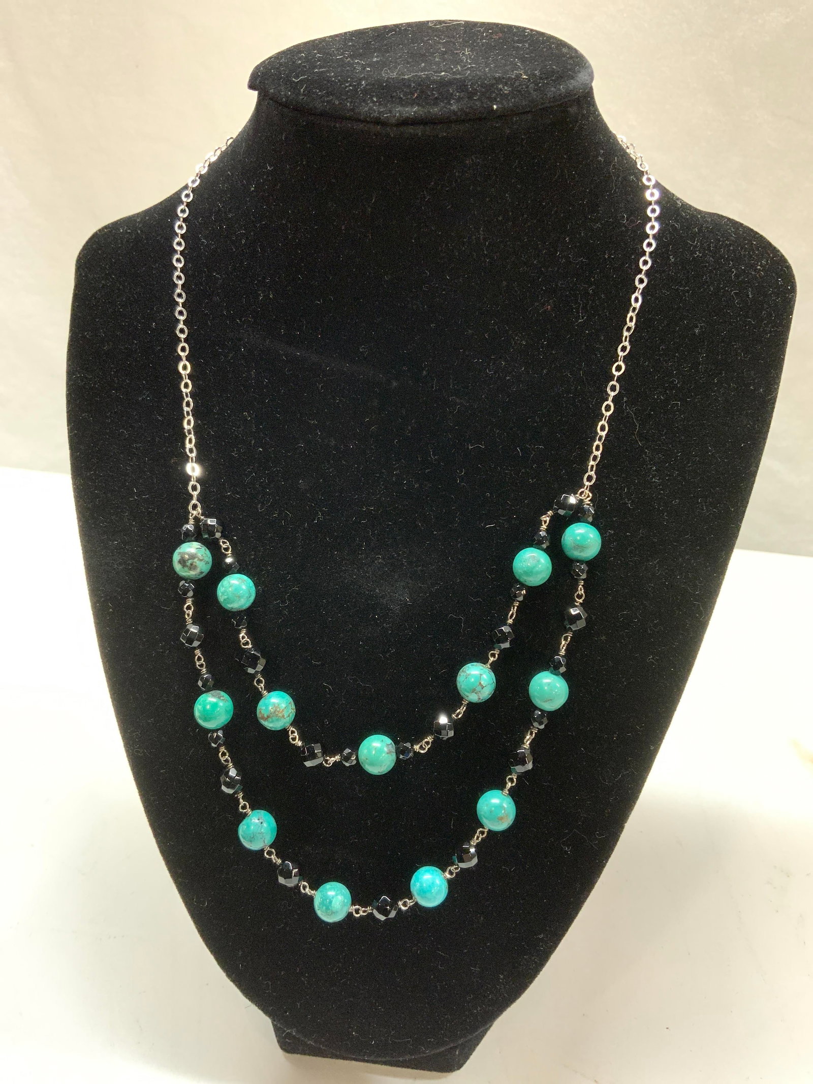 AF Sterling Silver Turquoise Bead Necklace: Sterling silver necklace with stationary turquoise round beads and faceted black jet beads. Double strand drape. Lobster clasp is marked .925 and AF 70 cts, .04 ozt. Necklace drop is 5.5 in. Sterling 