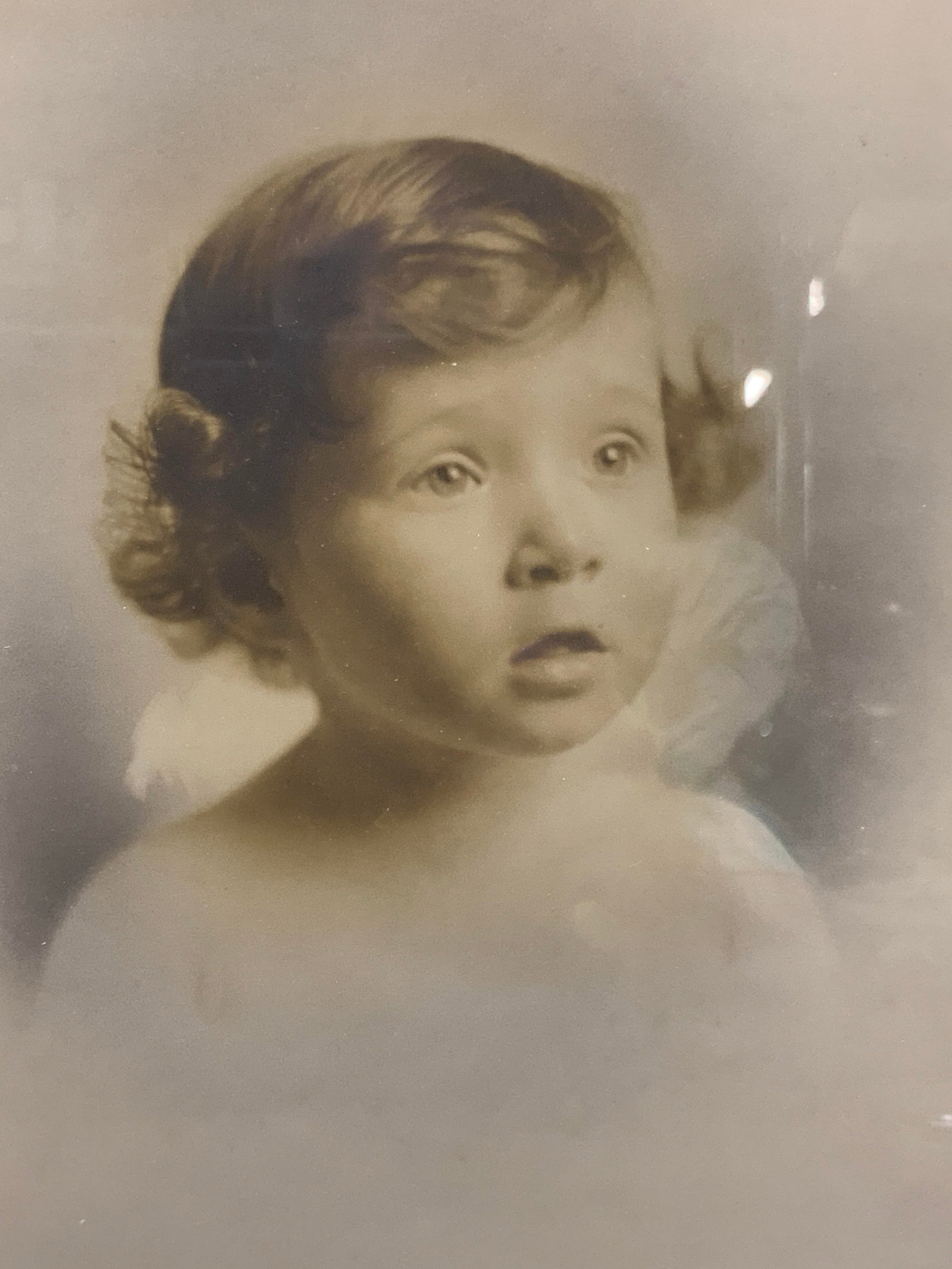 Vintage Baby Portrait photograph: Vintage portrait of a toddler with curly hair. Framed in a gold leafed wooden frame with off white mat board. Approx 15 x 13 inches, window measures 10 x 7,75 inches. Moderate wearing to frame and dis