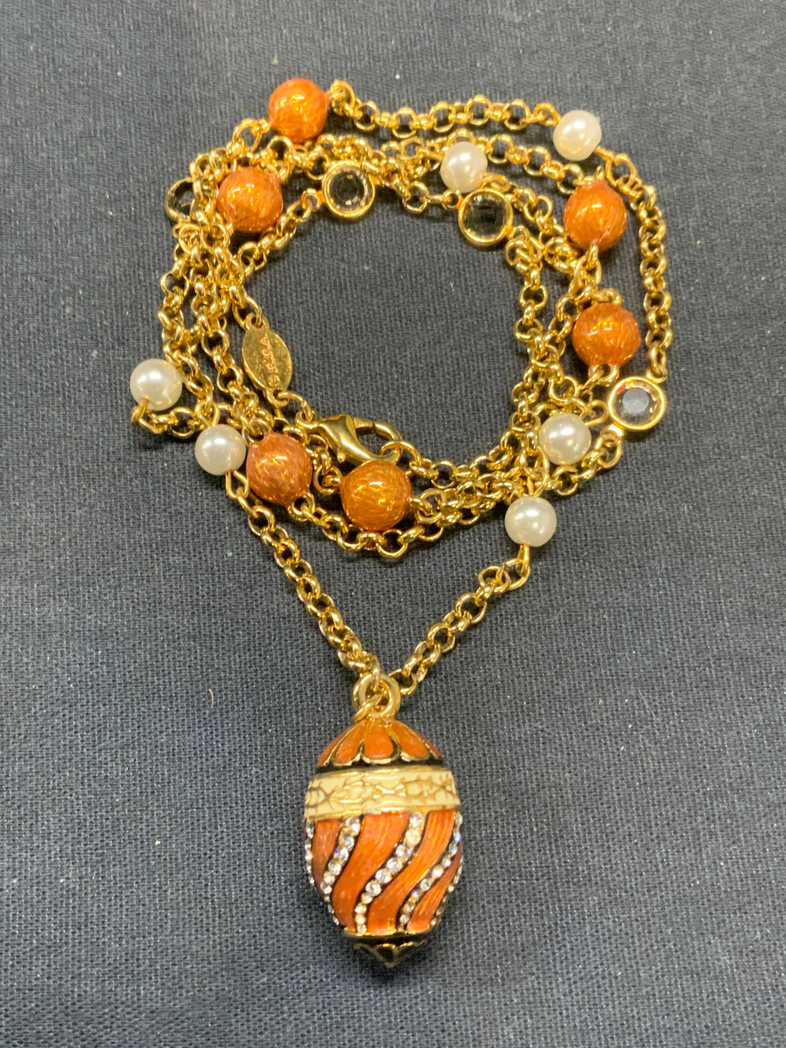 MMA Gold Tone Faux Pearl Enamel Pendant Necklace: Metropolitan Museum of Art gold tone pendant necklace with faux pearl, crystal, and enamel beads and enameled pave crystal decorated pendant. Signed on clasp. Drop length approx. 12.5 inches. Pendant 