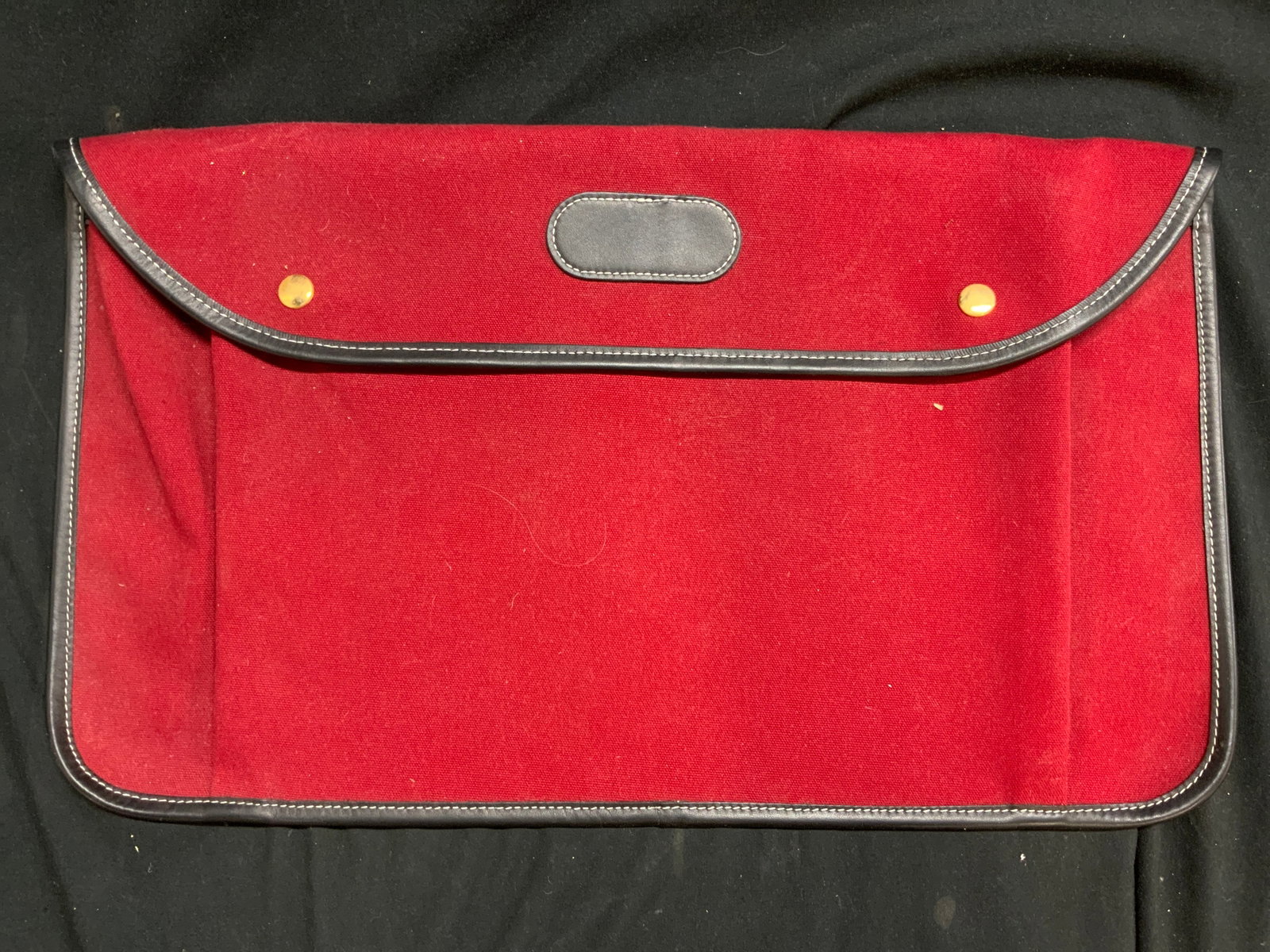 Canvas & Leather Laptop Business Bag: Laptop bag is red toned canvas with black toned trim with appears to be leather. Beige interior and gilt metal snap buttons. Piece measures approximately 20 inches wide 12 inches tall. Business bag, l