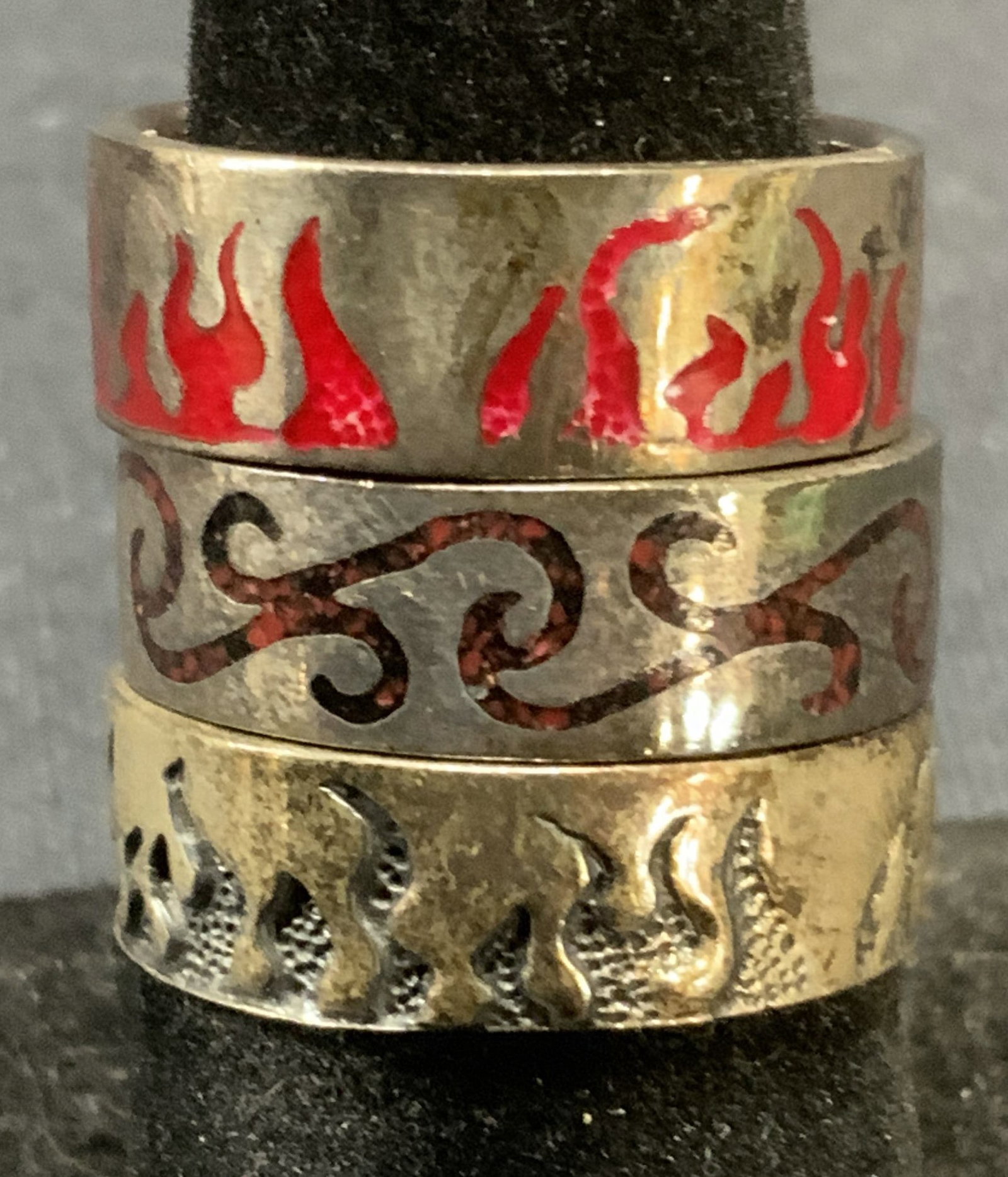 Lot 3 Sterling Silver Frame Rings: Lot of 3 sterling silver rings. 2 rings with enamel and etched flame motif and 1 ring with inlaid stone decoration. All pieces marked 925. Total weight of all pieces .40 ozt. 2 rings size 7.25 1 ring 