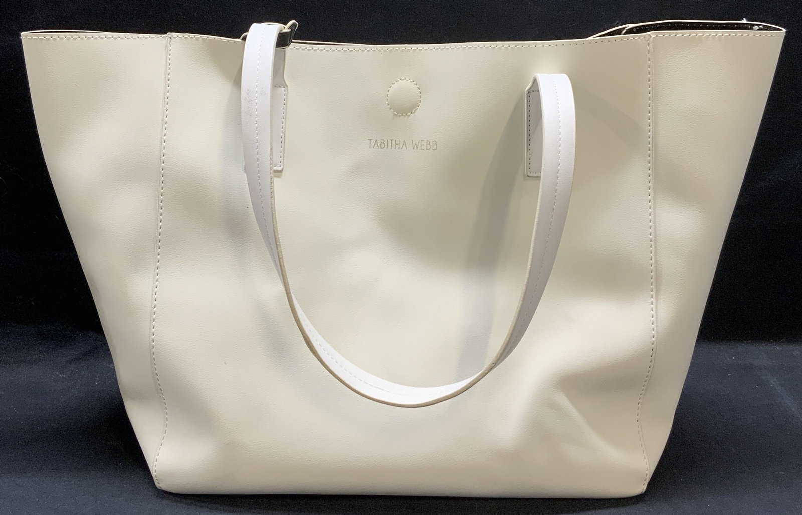 Tabitha Webb White Leather Tote Handbag: Tabitha Webb white leather tote handbag. Signed to exterior and interior. 1 slip pocket to interior. Includes zippered pouch. Handbag measures approx. 13.5 x 8 x 13 inches. Some wear to leather and bl
